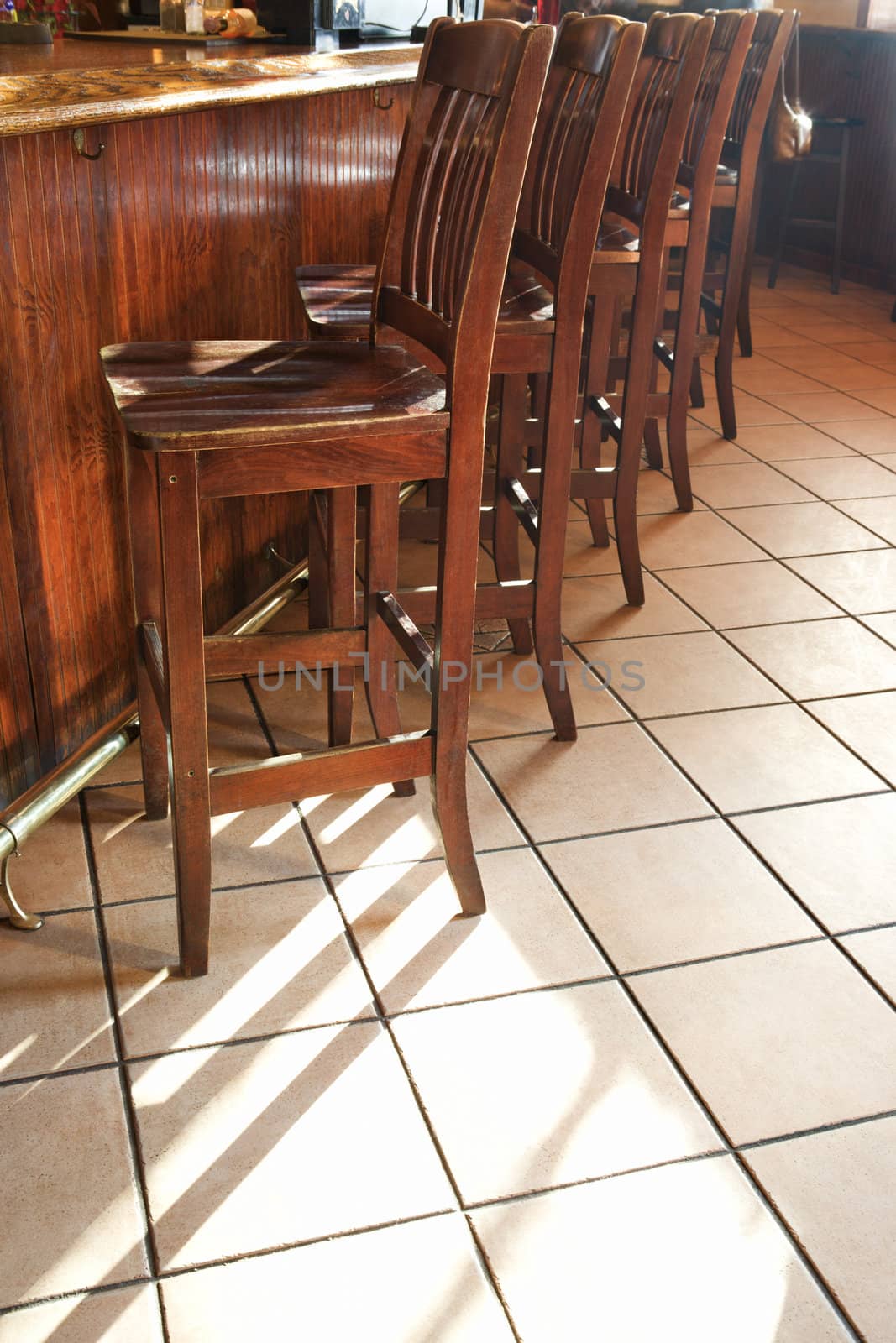 Bar stools at bar. by iofoto