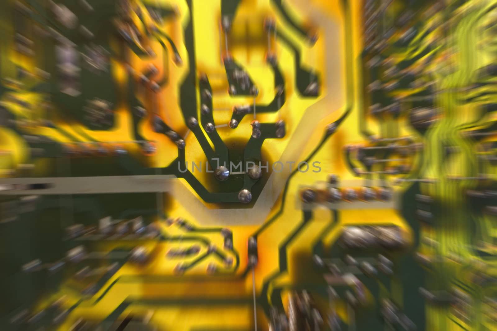 Colorful television/computer circuit board, focus on center with zoom blur, lit from behind