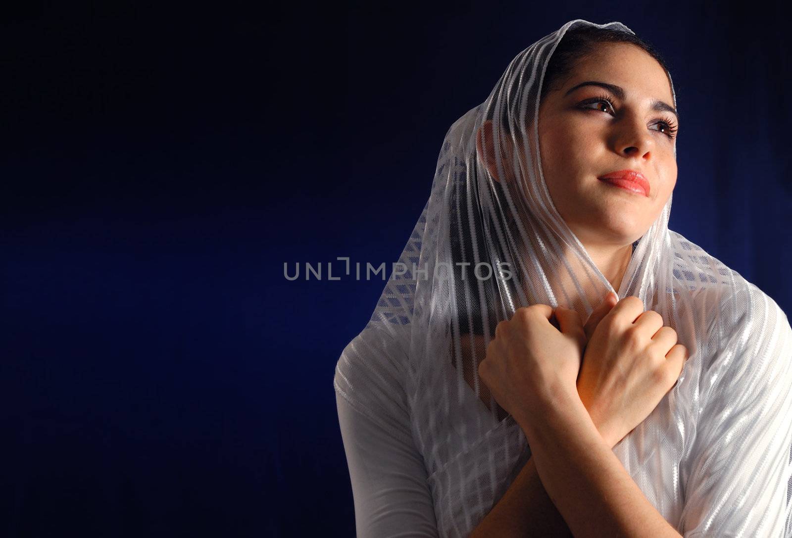 Portrait of young hispanic woman with veil