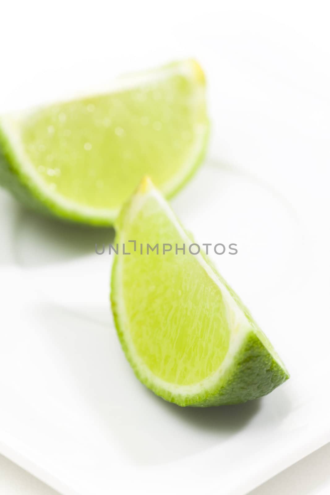 Fresh limes on white plate