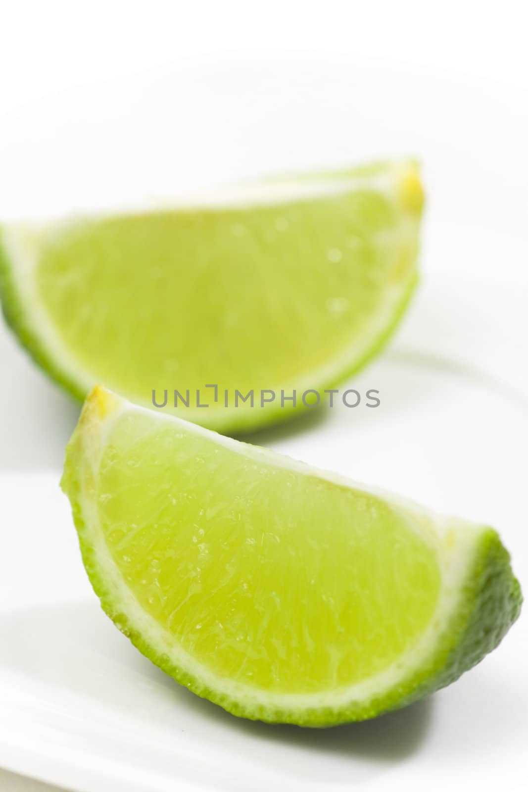 Fresh limes on white plate