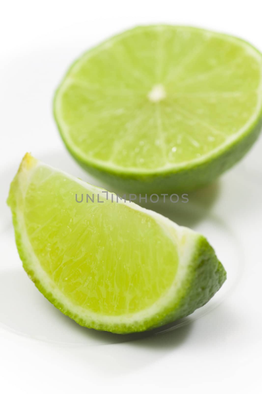 Fresh limes on white plate
