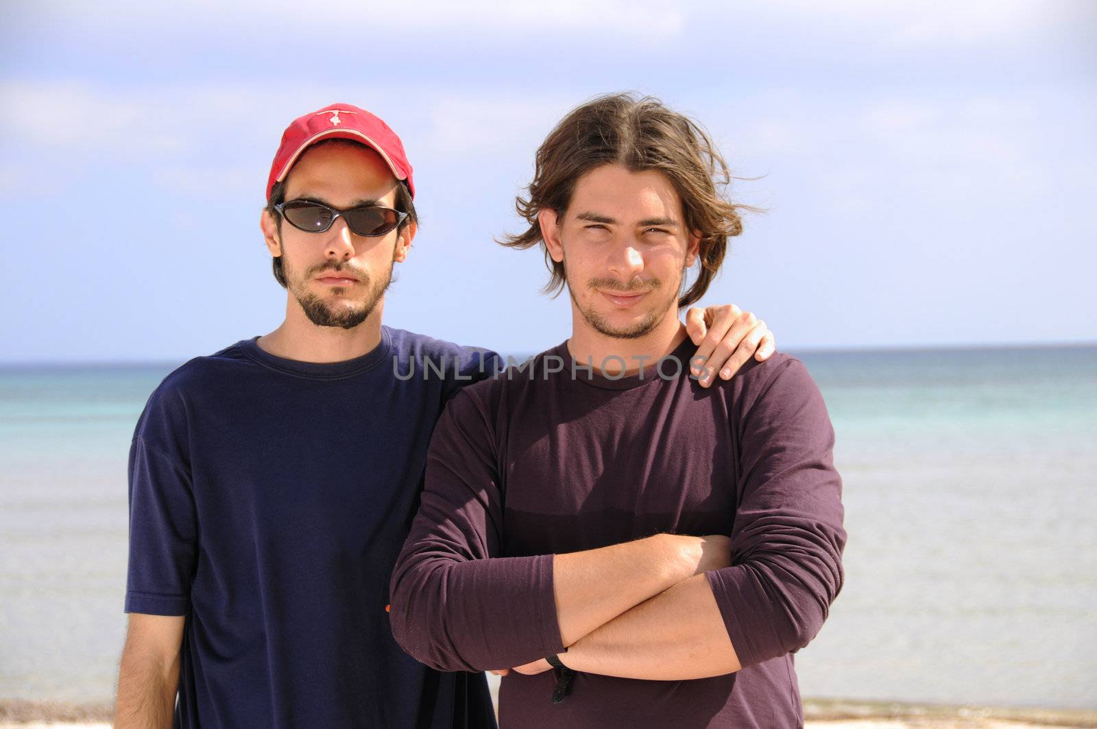 Portrait of two friends posing on the beach