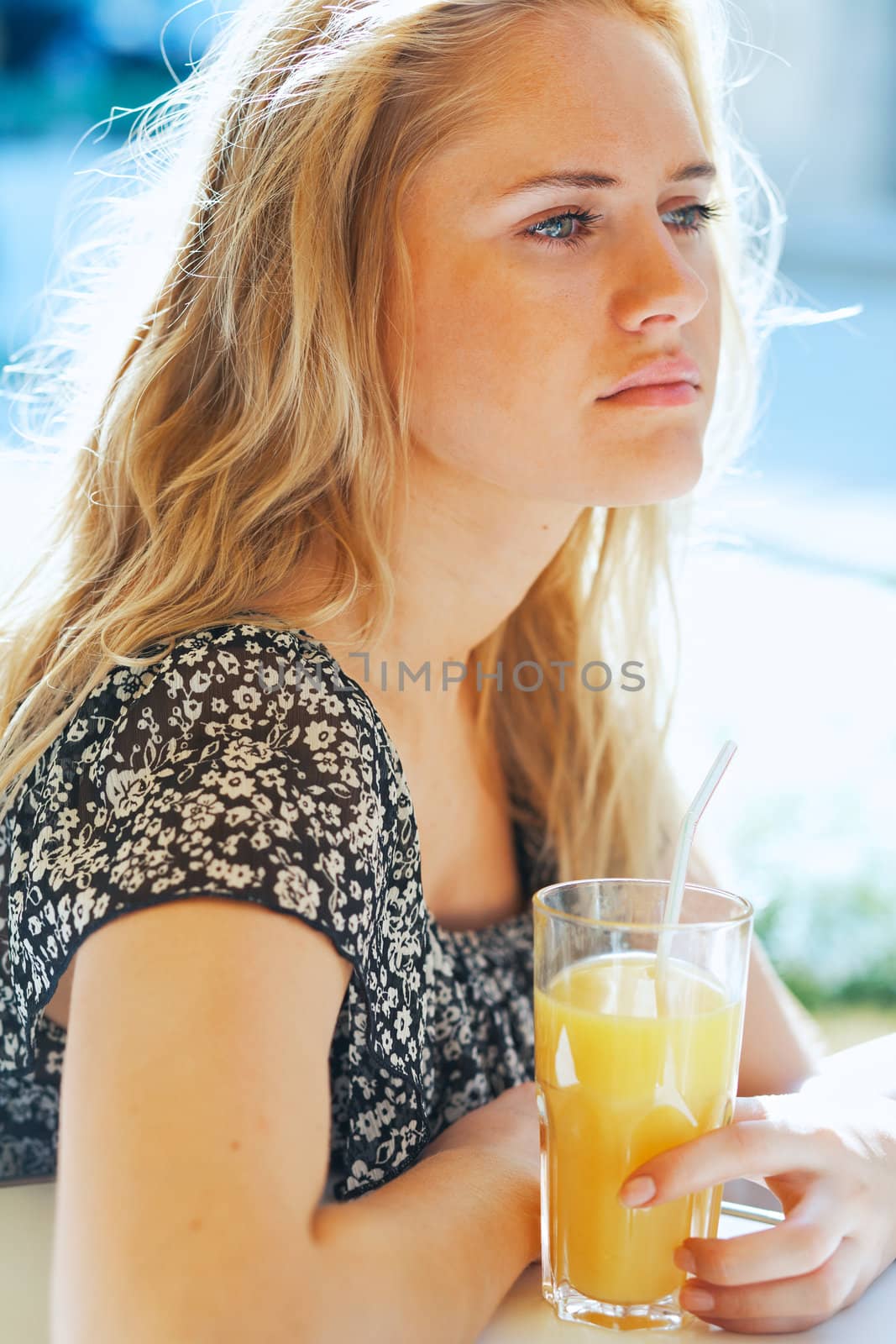 Young attractive woman with a glass of orange juice