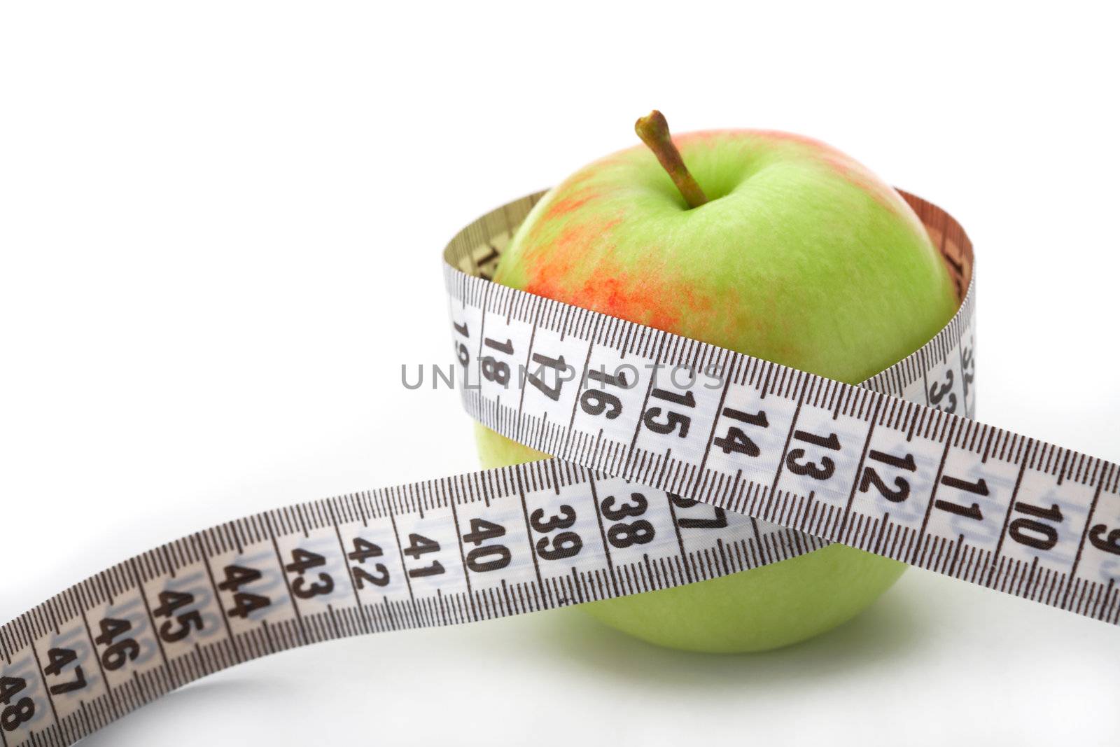 Apple with a measuring tape on white