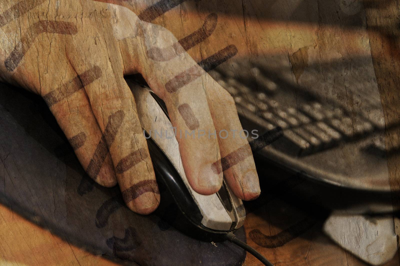 Detail of hand on mouse and keyboard over grunge background
