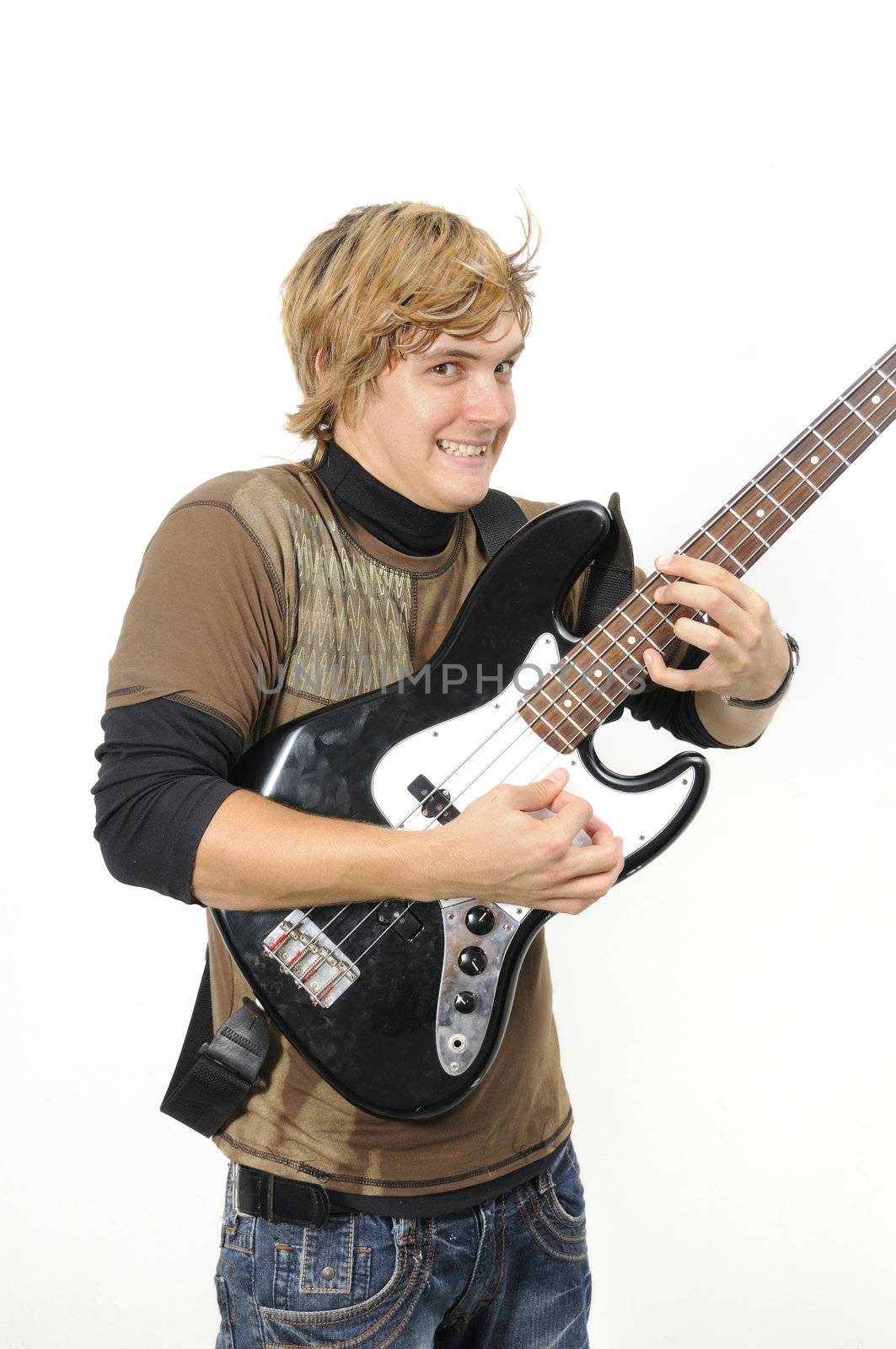 Portrait of trendy young male playing electric bass - isolated