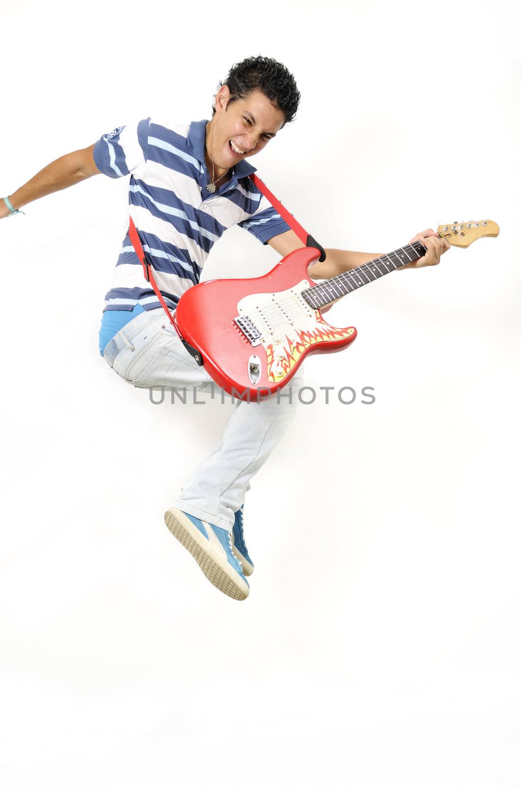 Portrait of trendy teen jumping with electric guitar - isolated