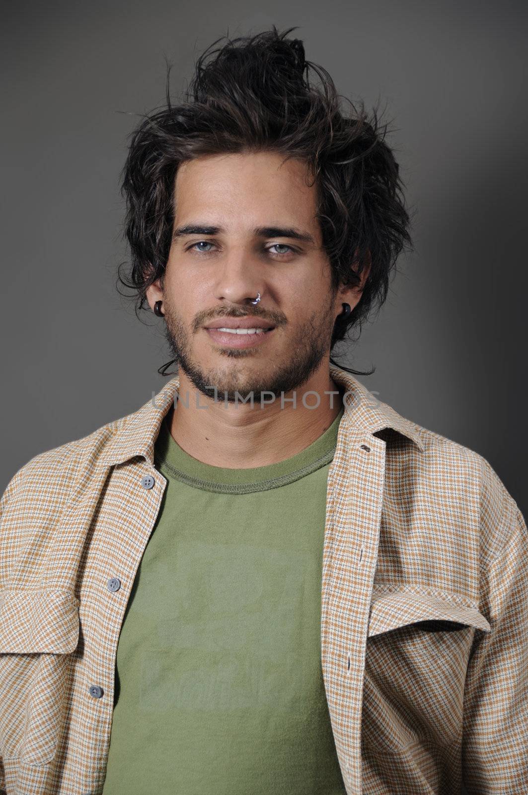 Portrait of young handseme male with nose piercing