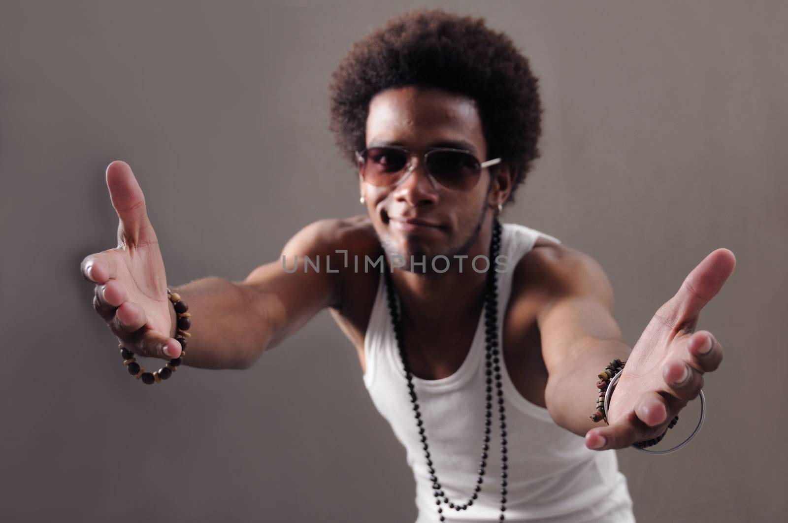 Portrait of young african male with open arms towards the camera