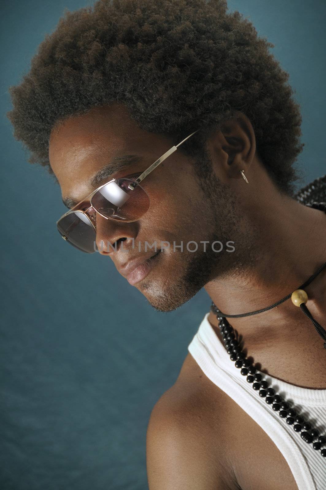 Portrait of young handsome african male wearing sunglasses