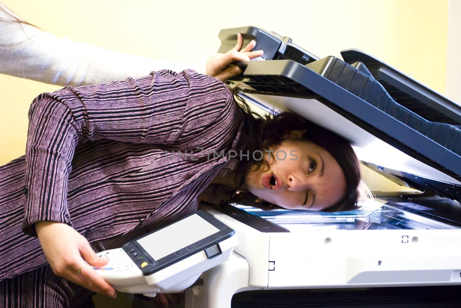 colleagues making fun in office with copier
