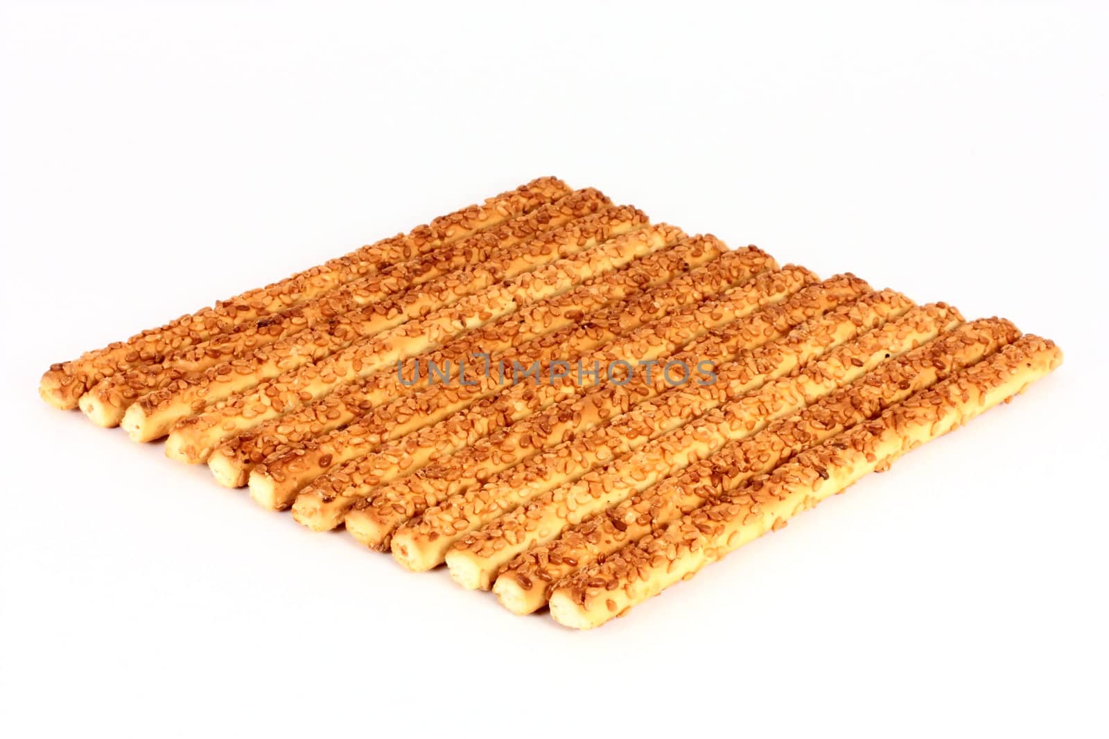 Many breadsticks with sesame seeds background