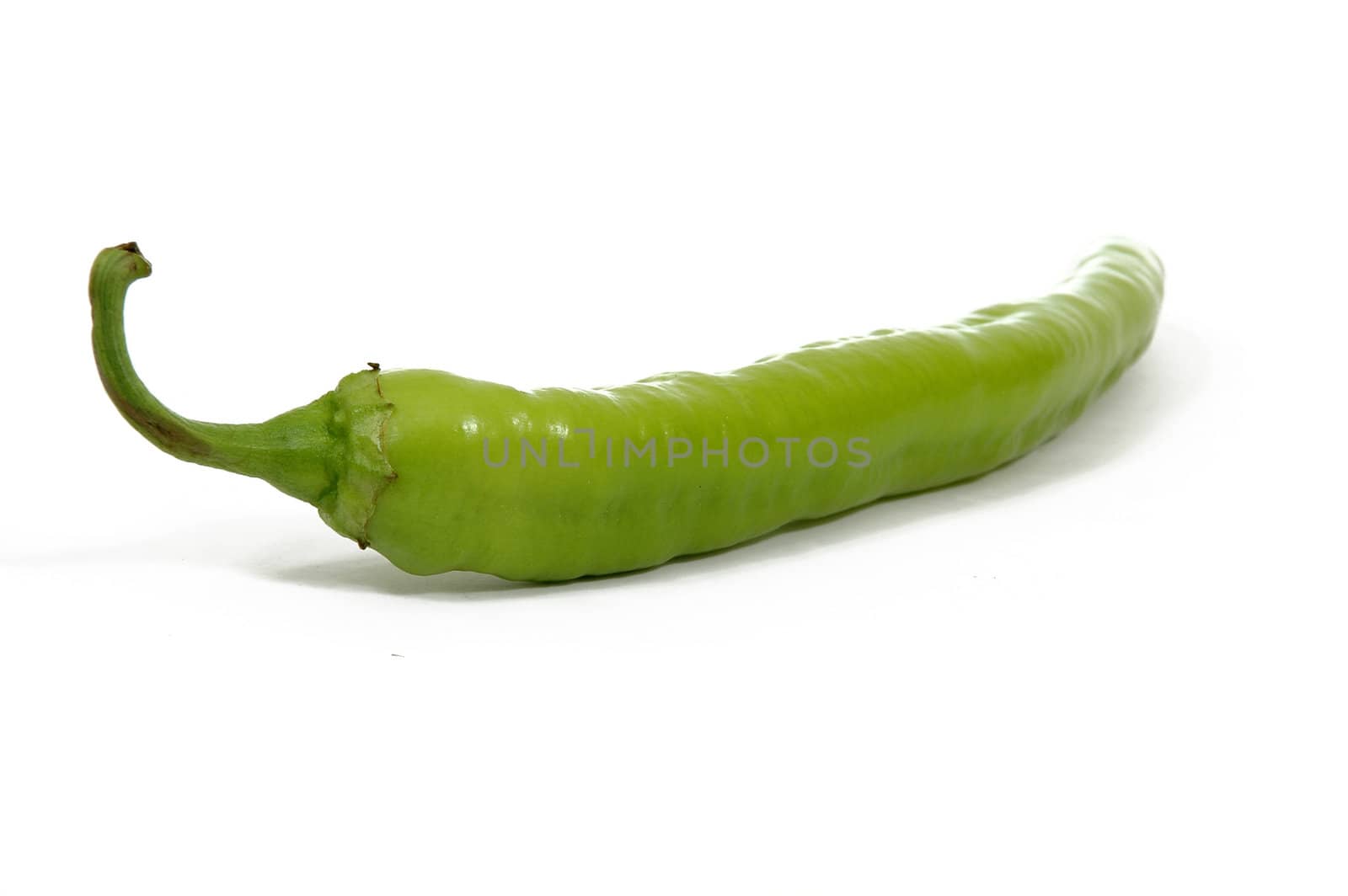 Green chilli peber on white background