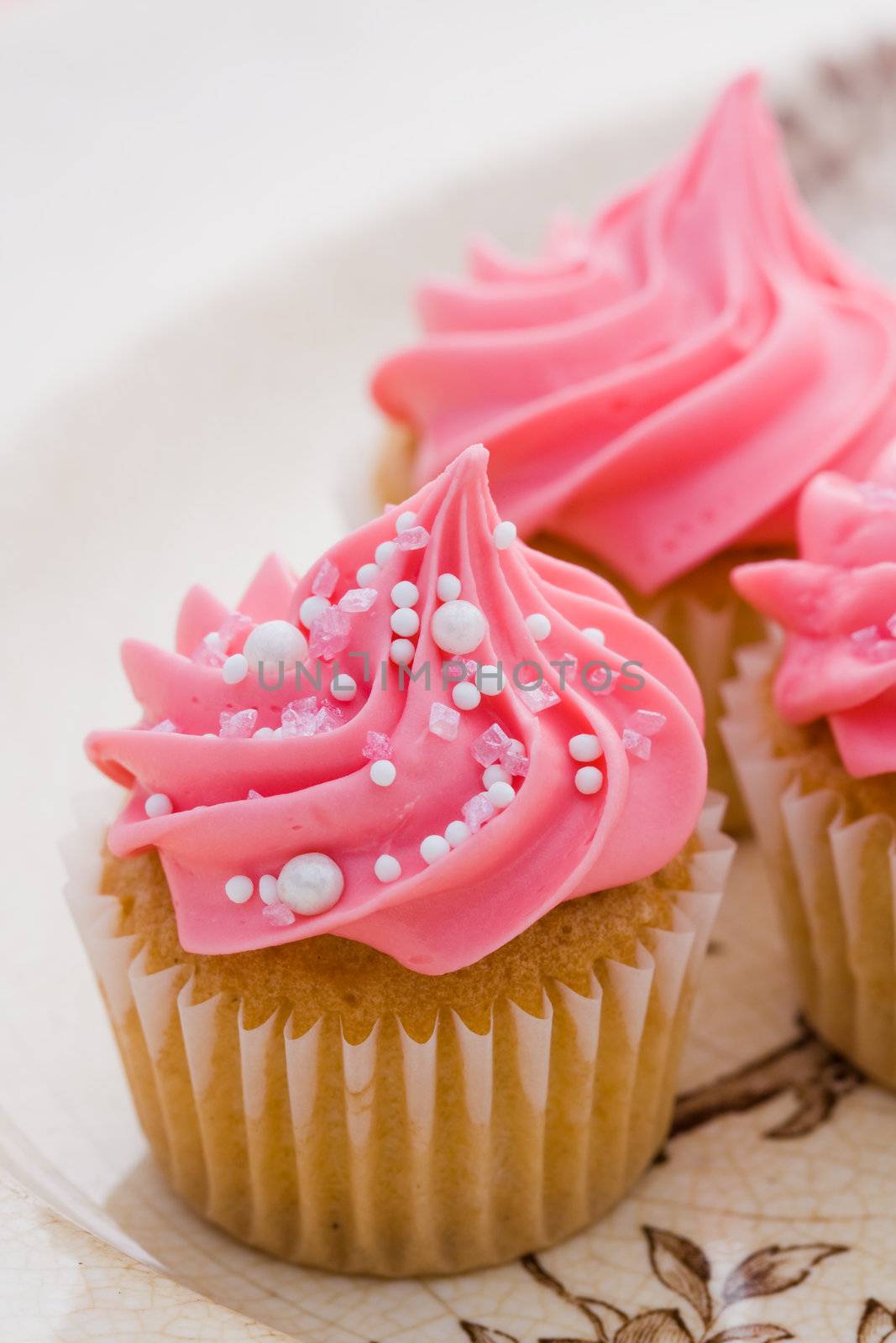Cupcakes decorated with pink frosting and sprinkles