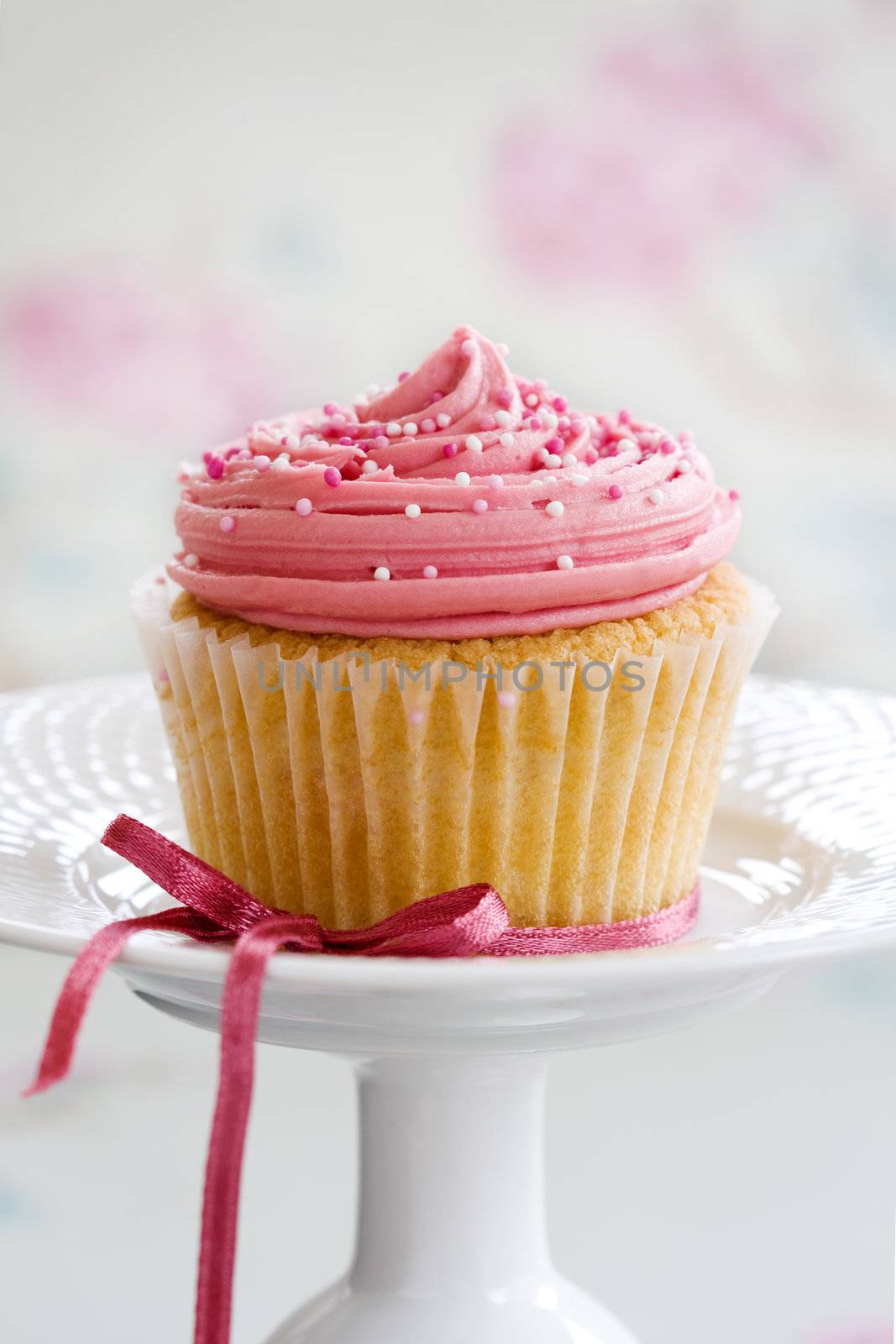 Pink cupcake on a cakestand