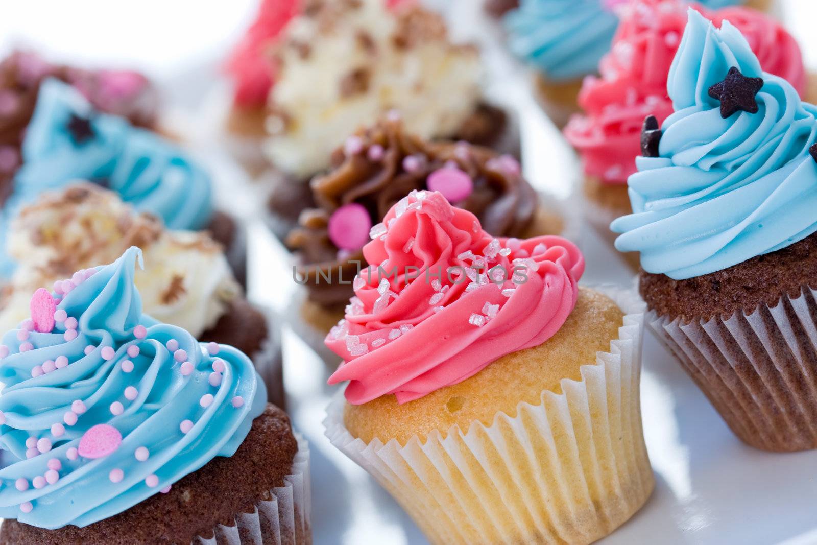 Assortment of brightly colored cupcakes