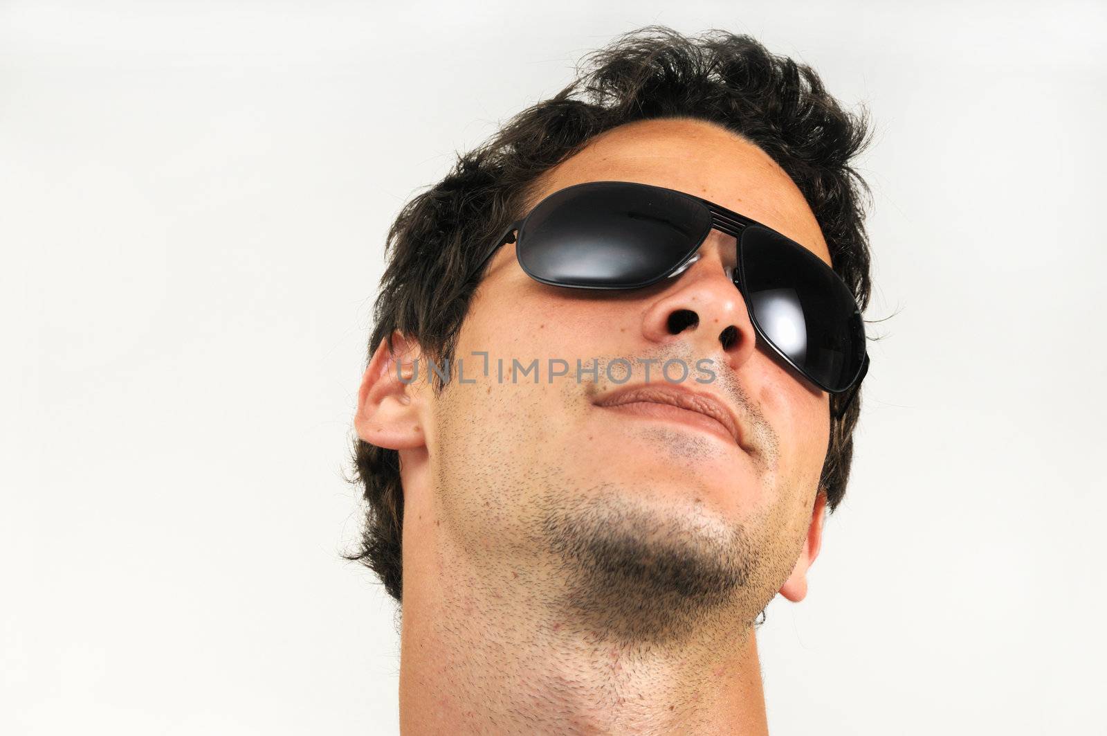 Portrait of fashionable young man wearing sunglasses - isolated