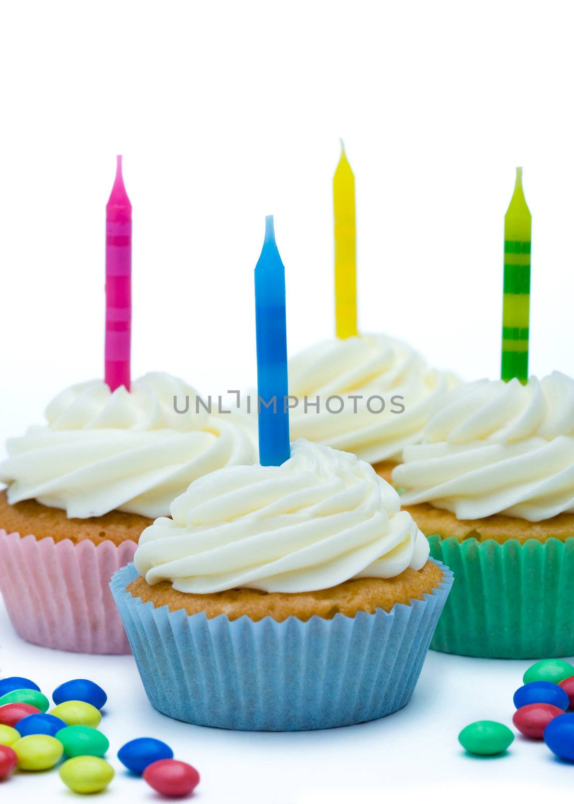 Cupcakes decorated with brightly colored candles