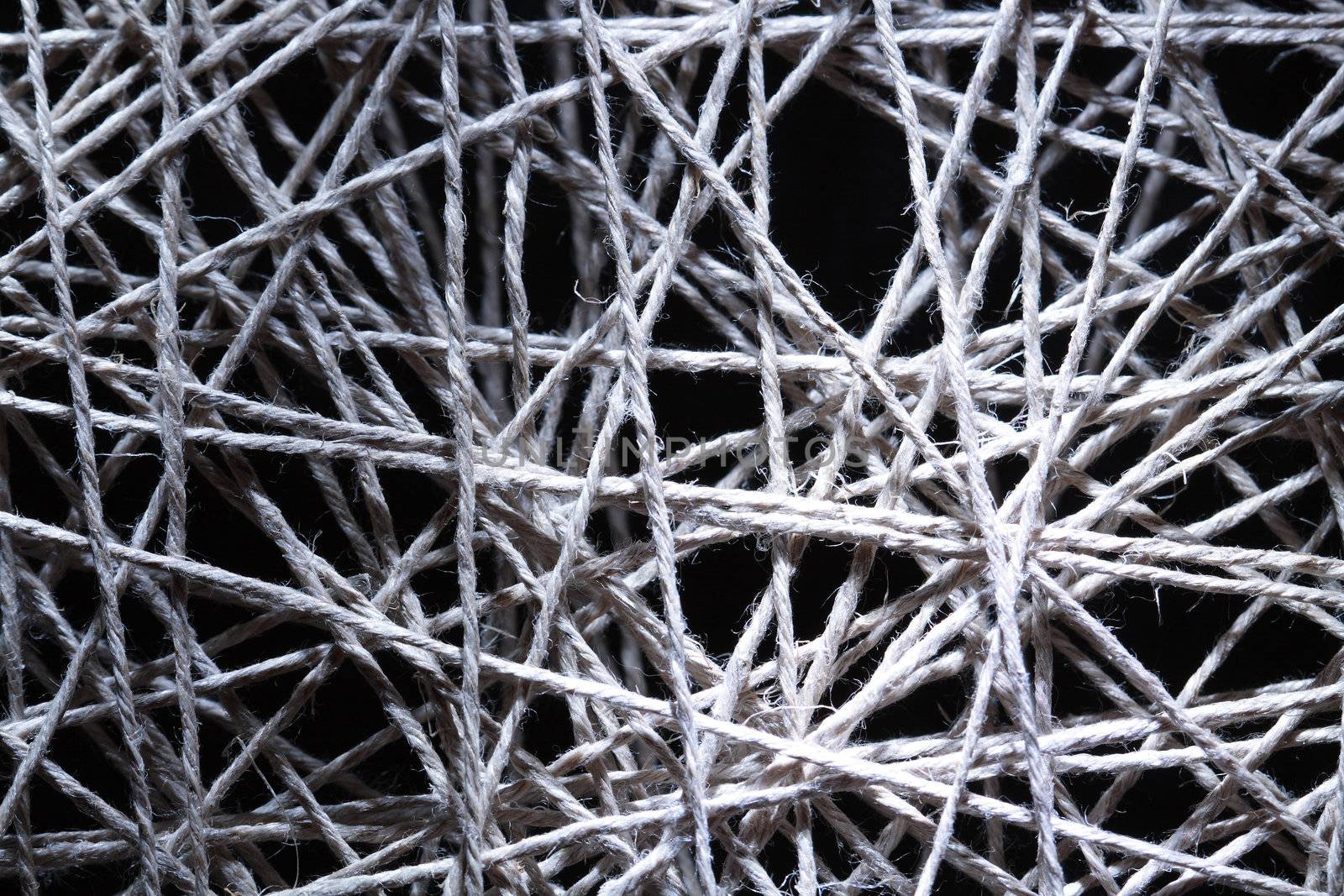 Background made from gray crossing rope on dark