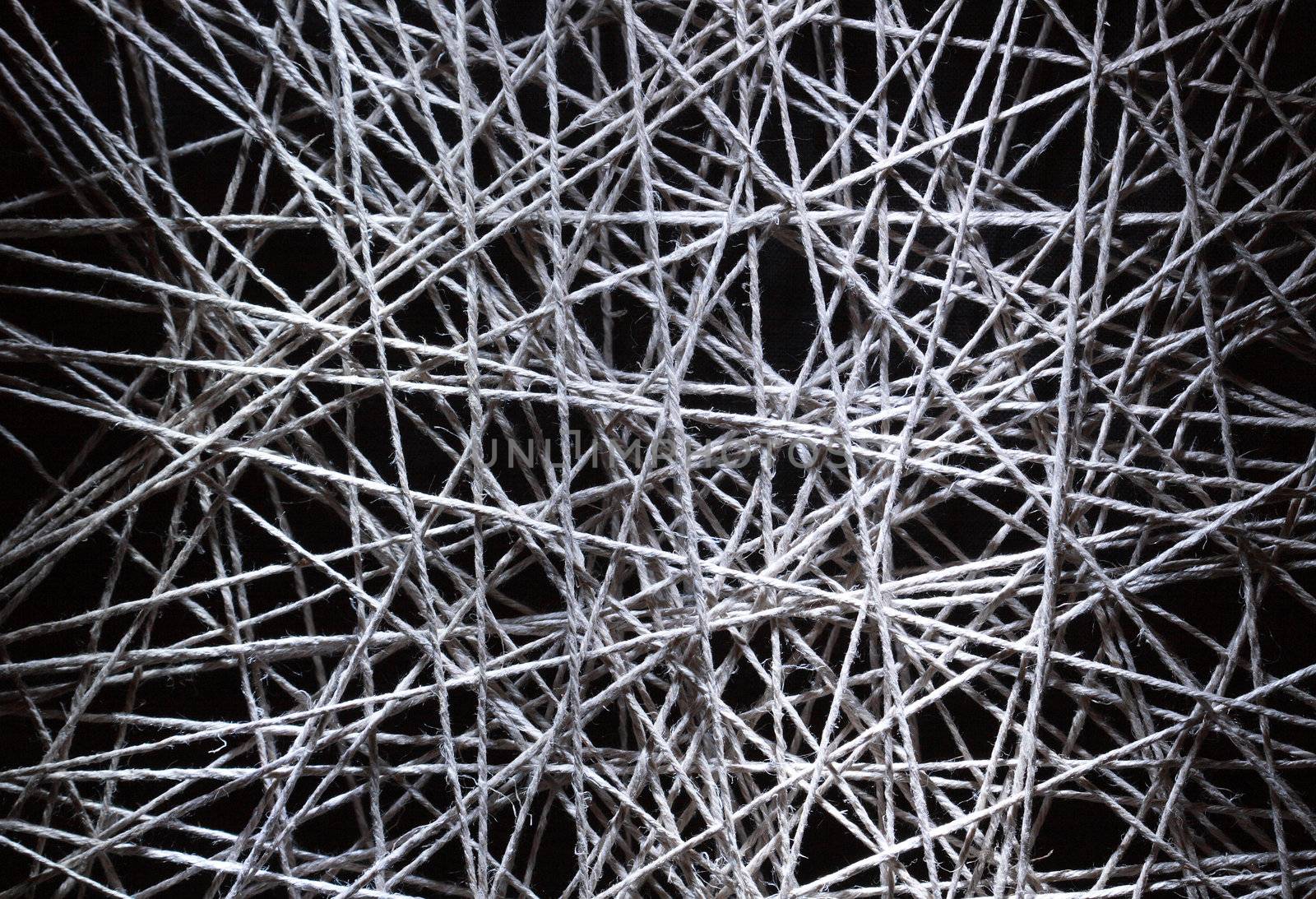 Background made from gray crossing rope on dark