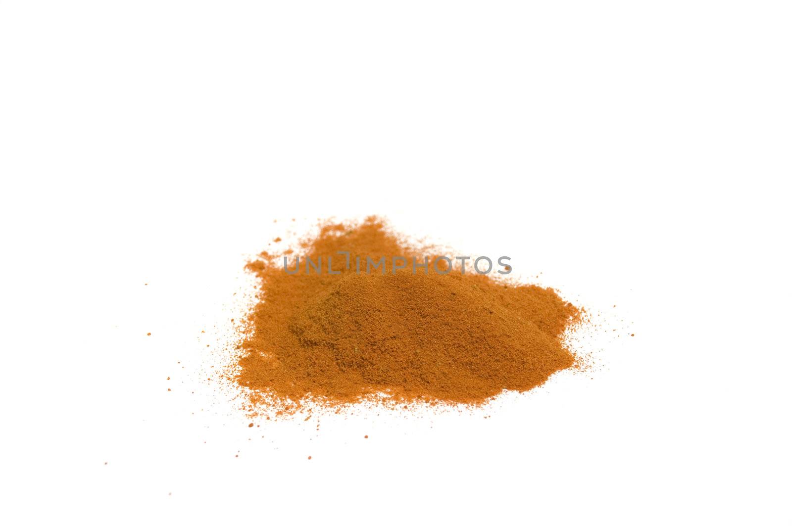 close up on a heap of hot chili powder, isolated on white