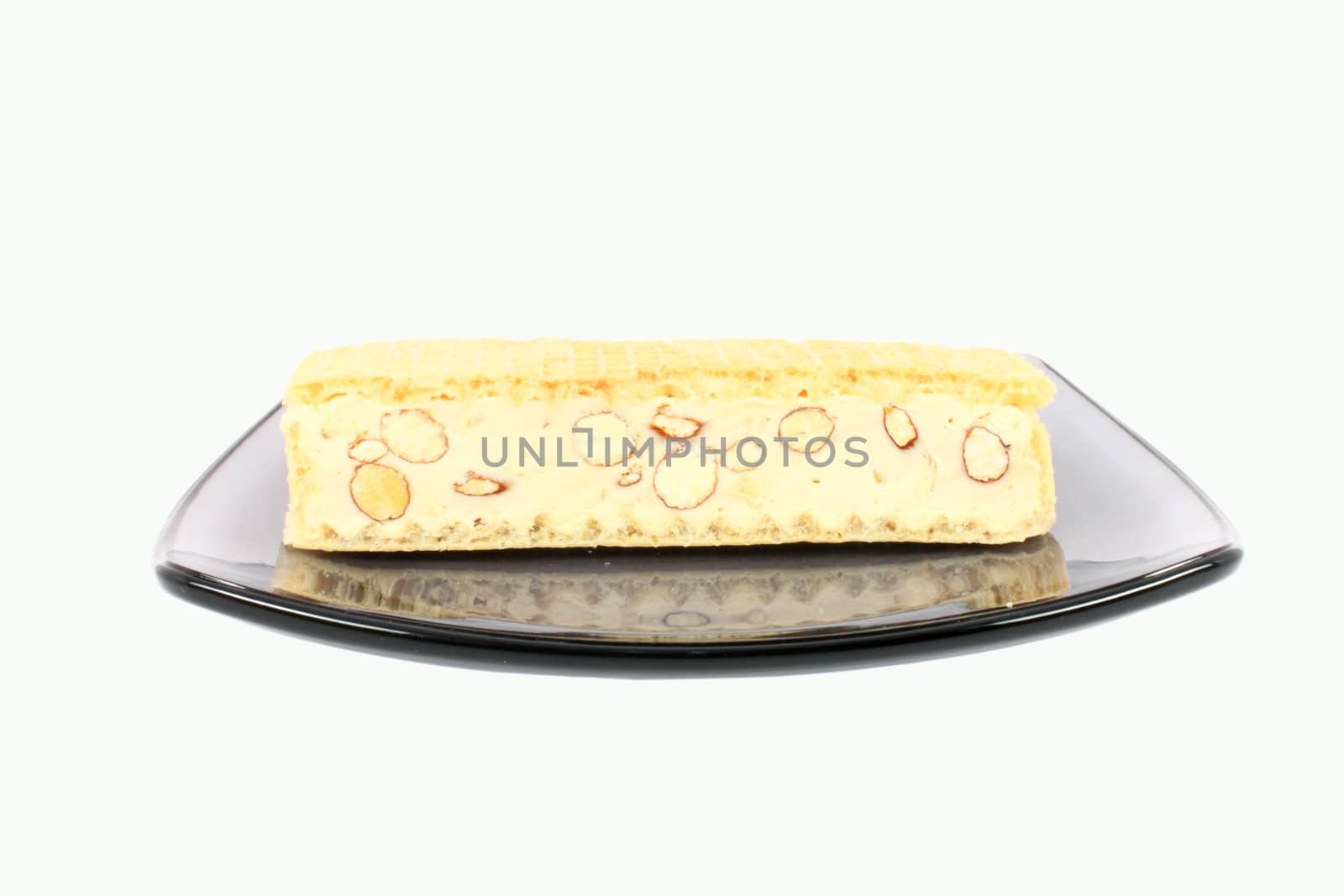 Almond nougat on plate, isolated on white