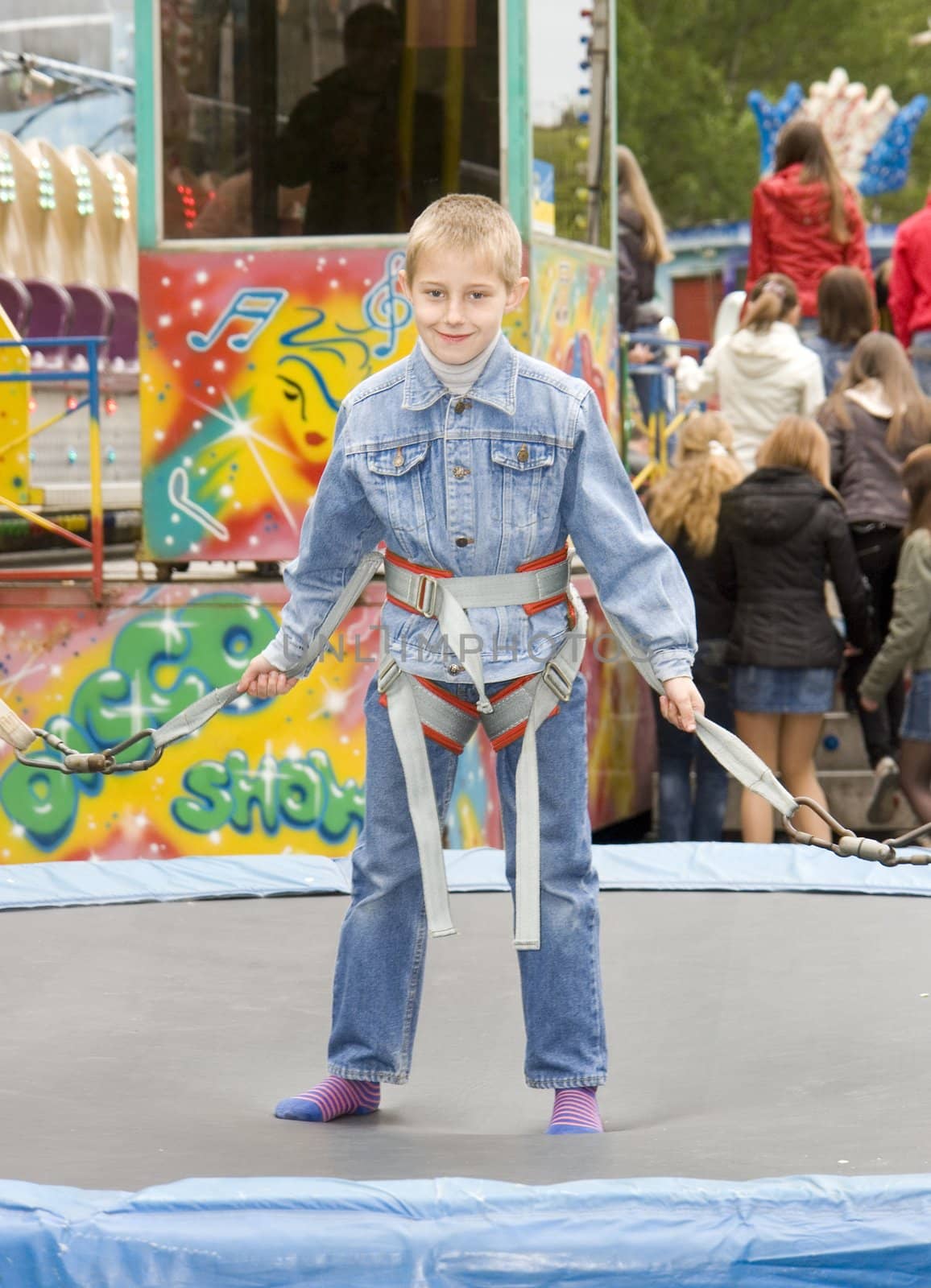 The jumping boy on an attraction in an amusement park