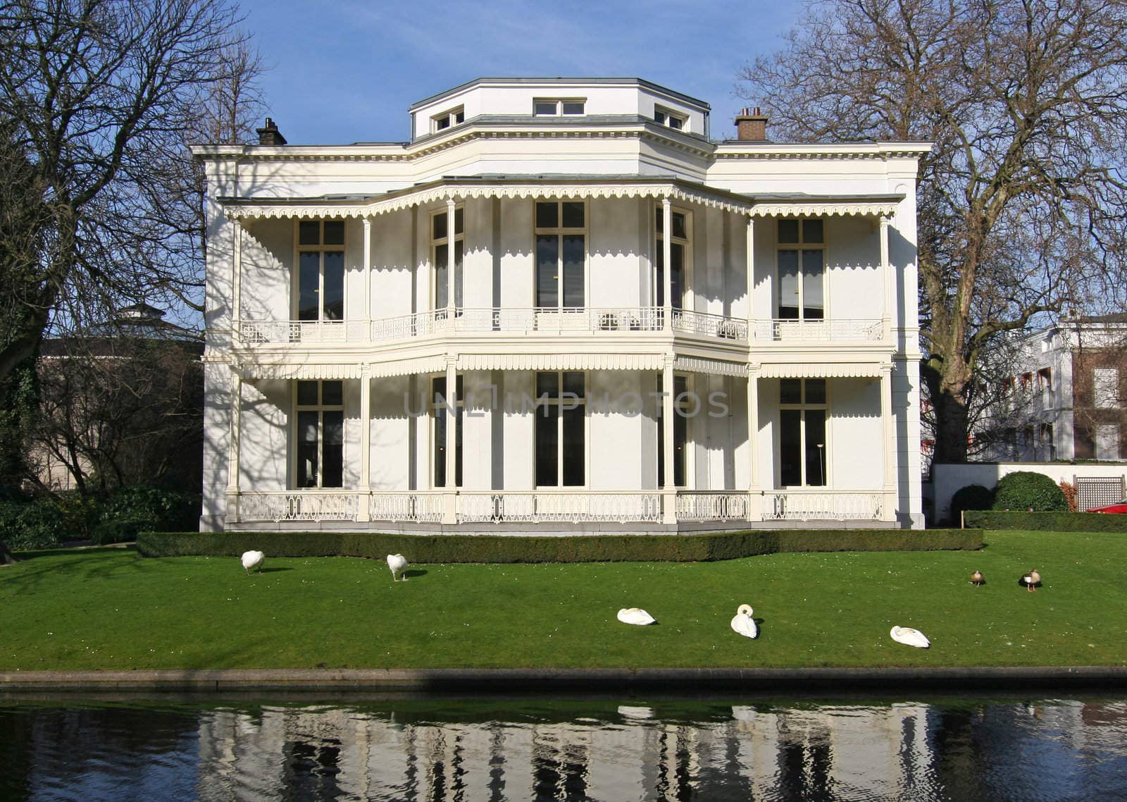 Classical white villa with swans