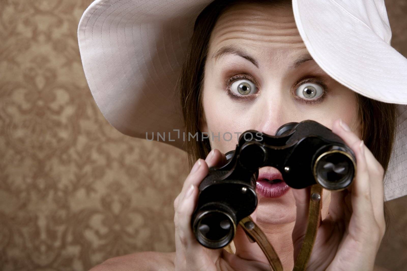 Young Woman with Sunglasses and a Floppy White Hat Looking through Binoculars