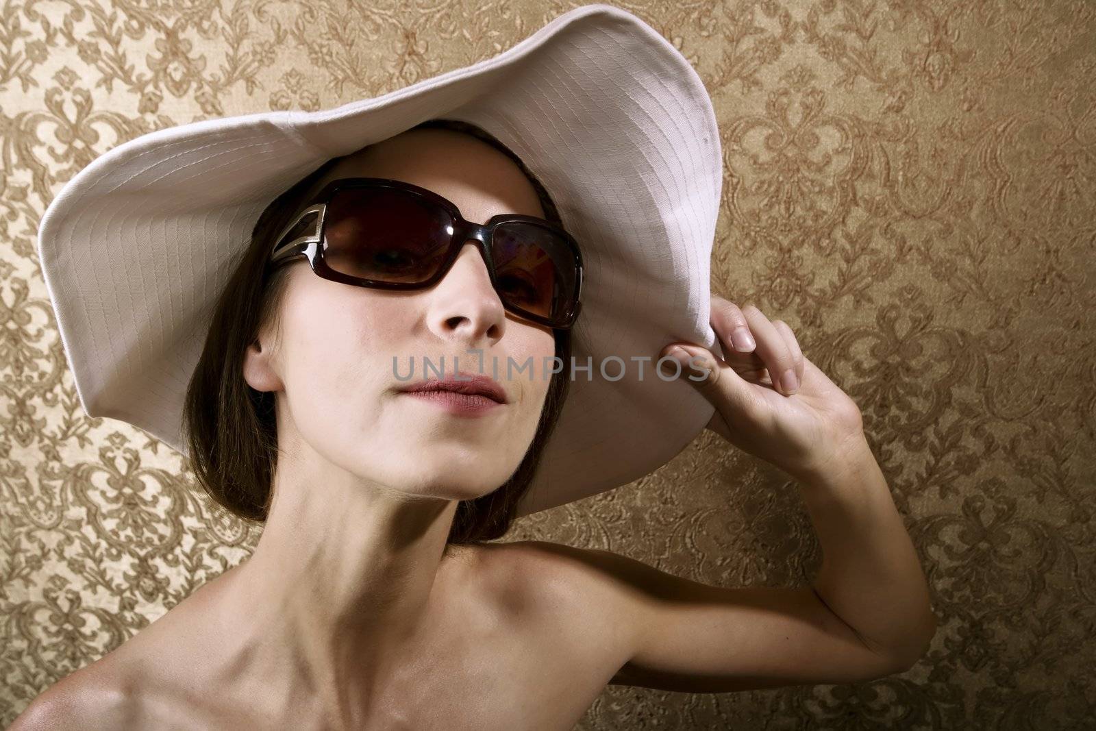 Young Woman with Sunglasses and a Floppy White Hat
