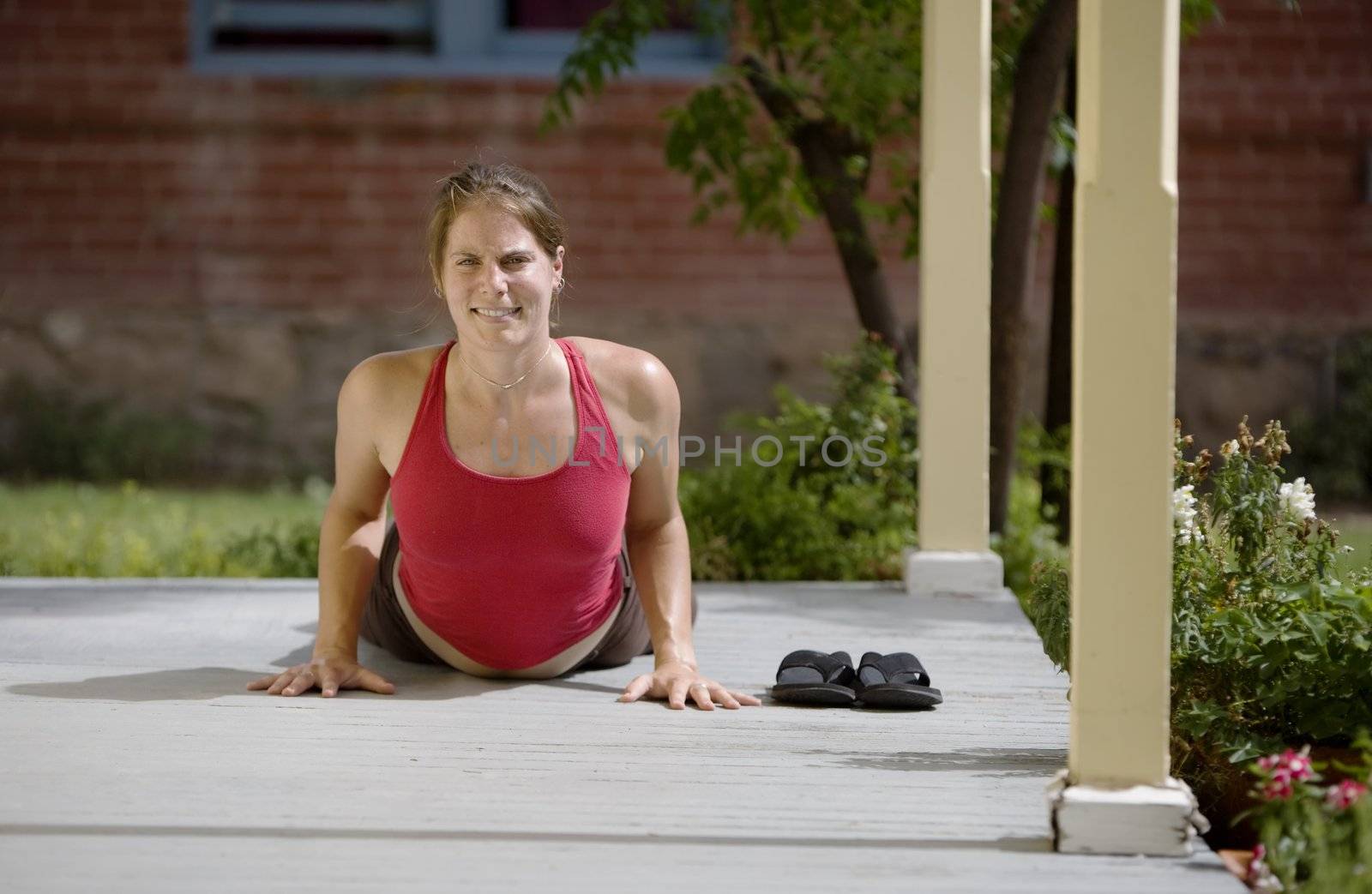 Pretty Young Woman doing Yoga on a Porch