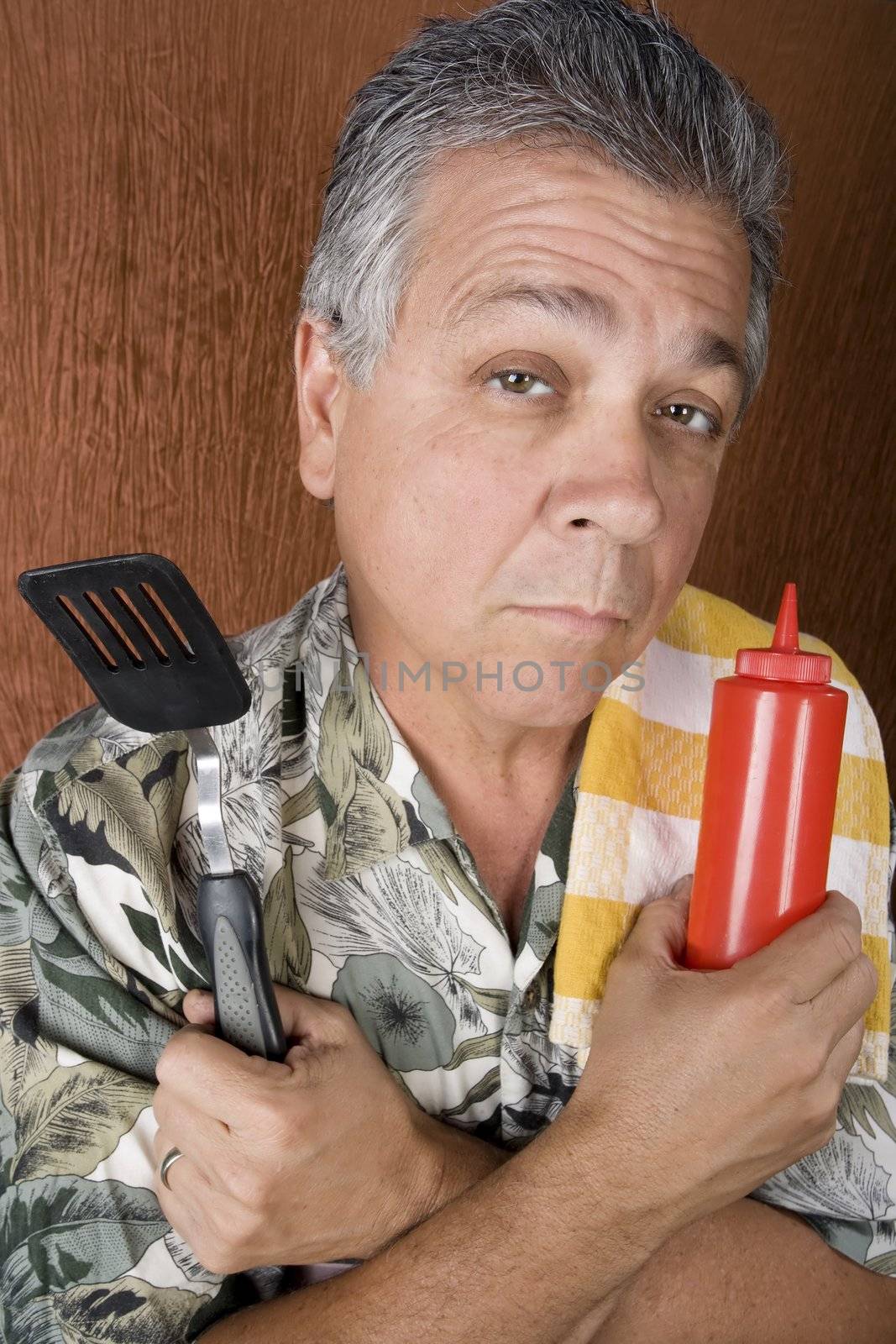 Latin American Man with Barbecue Implements and a Ketchup Bottle