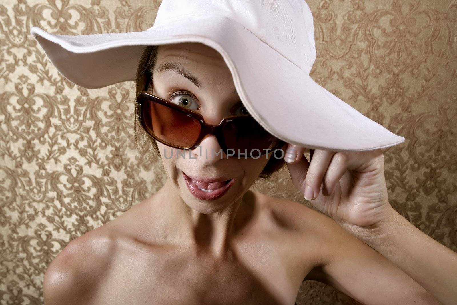 Young Woman with Sunglasses and a Floppy White Hat