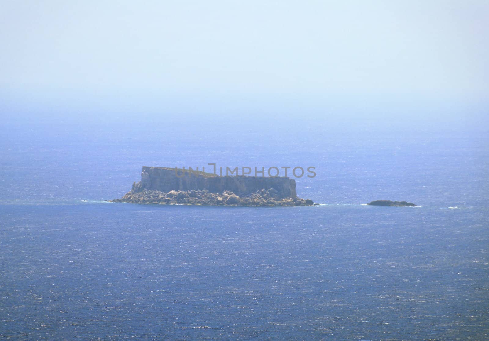 Filfla is a small, barren, uninhabited islet 5 km south of Malta. The image is taken from Dingli Cliffs, at 7,5km distance.
