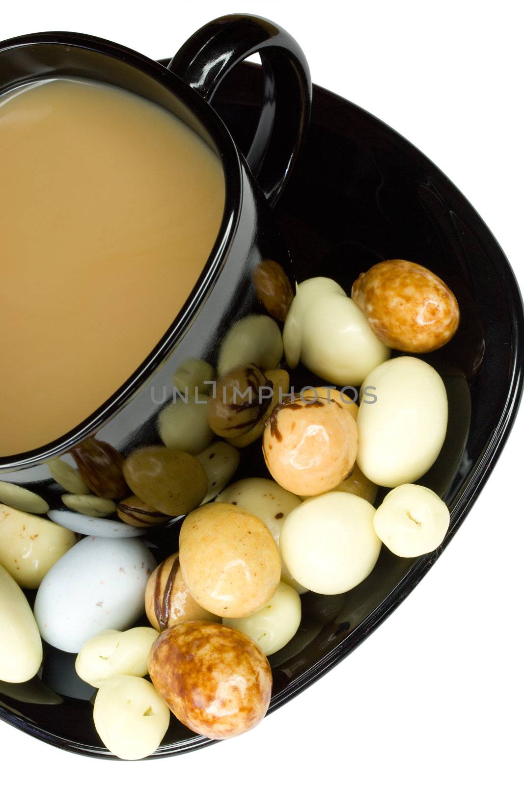 close-up black cup of coffee with milk and candies, isolated on white