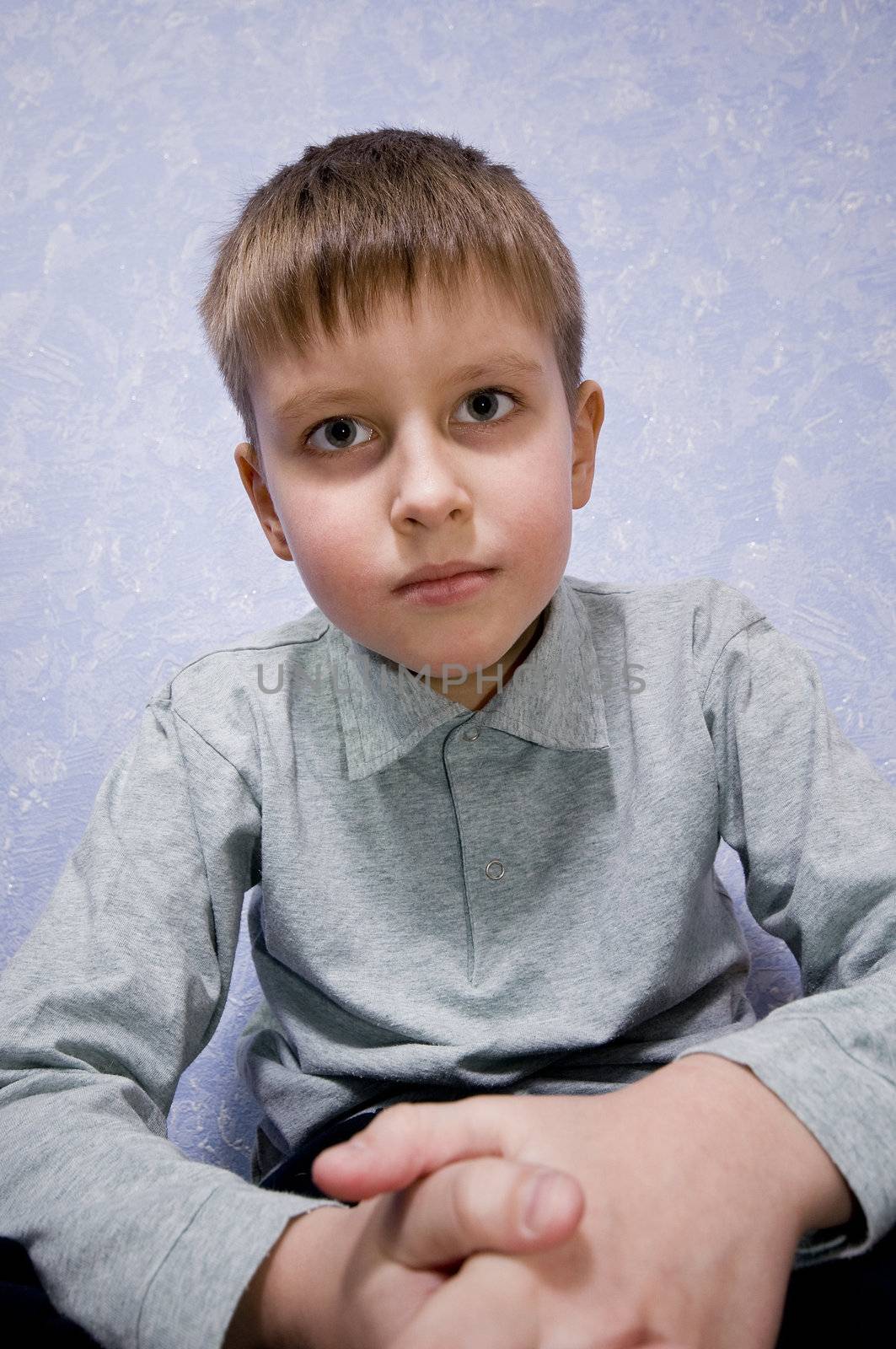 Adorable boy sad and gotten upset looking to camera