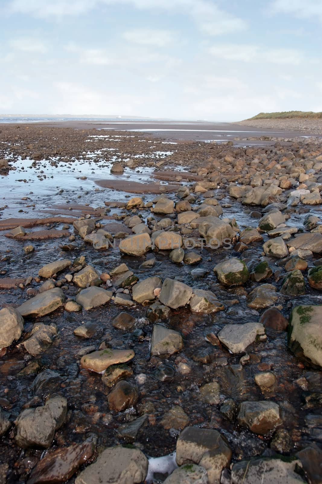 grey boulders and rocks on beale beach co kerry ireland on a cold winters day