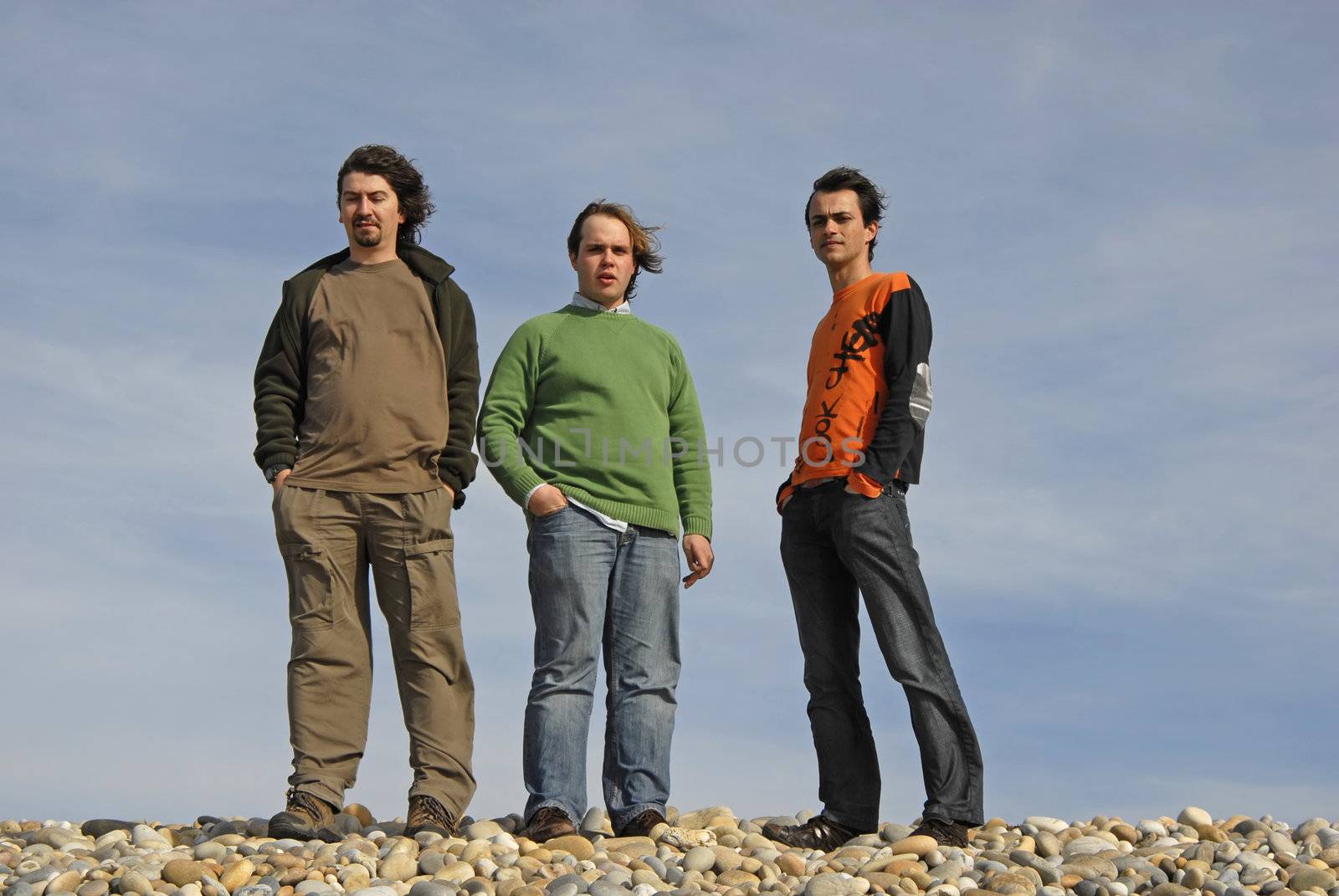 three casual young men at the beach