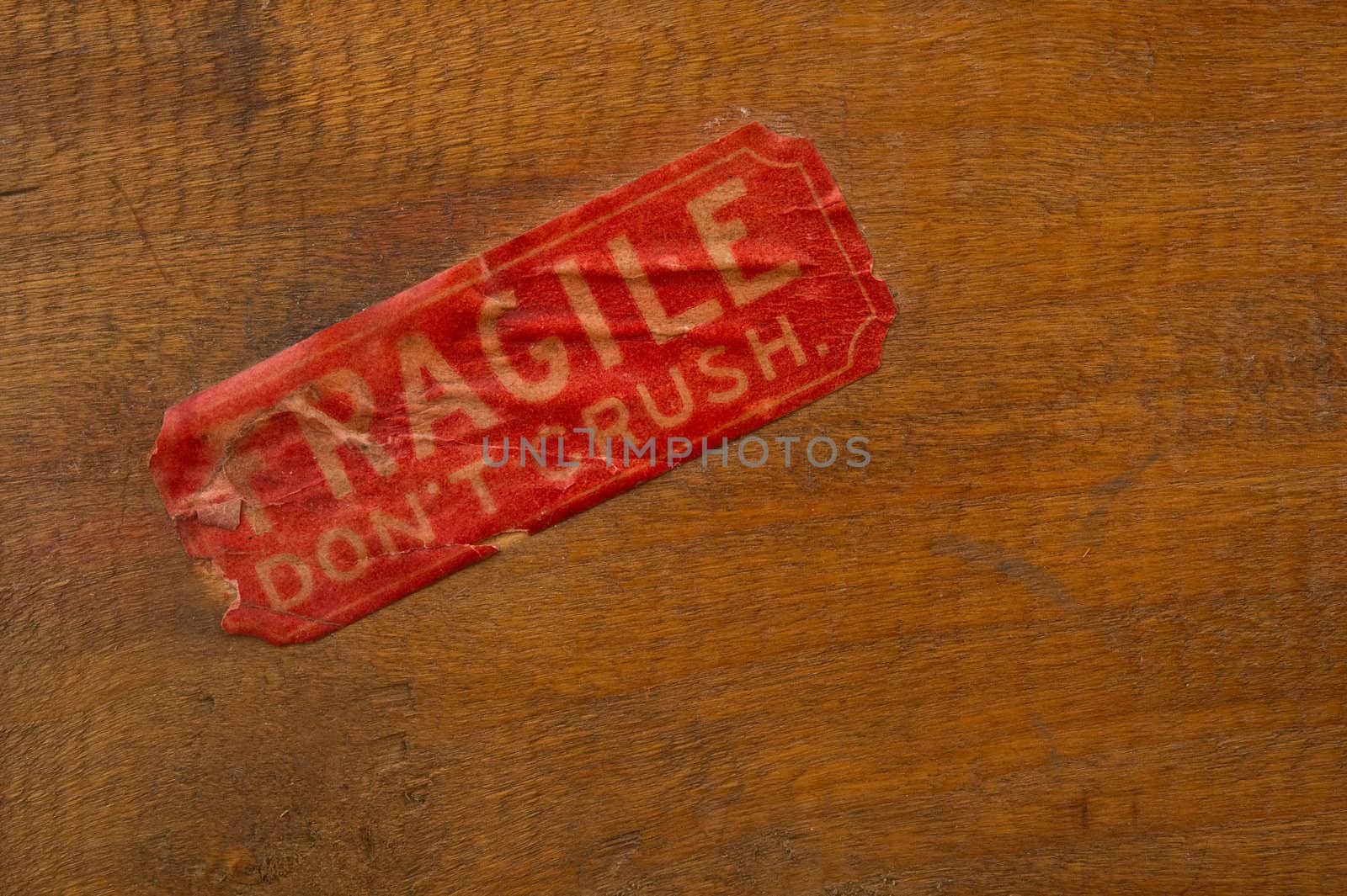 Image of an antiqued fragile label on wood background