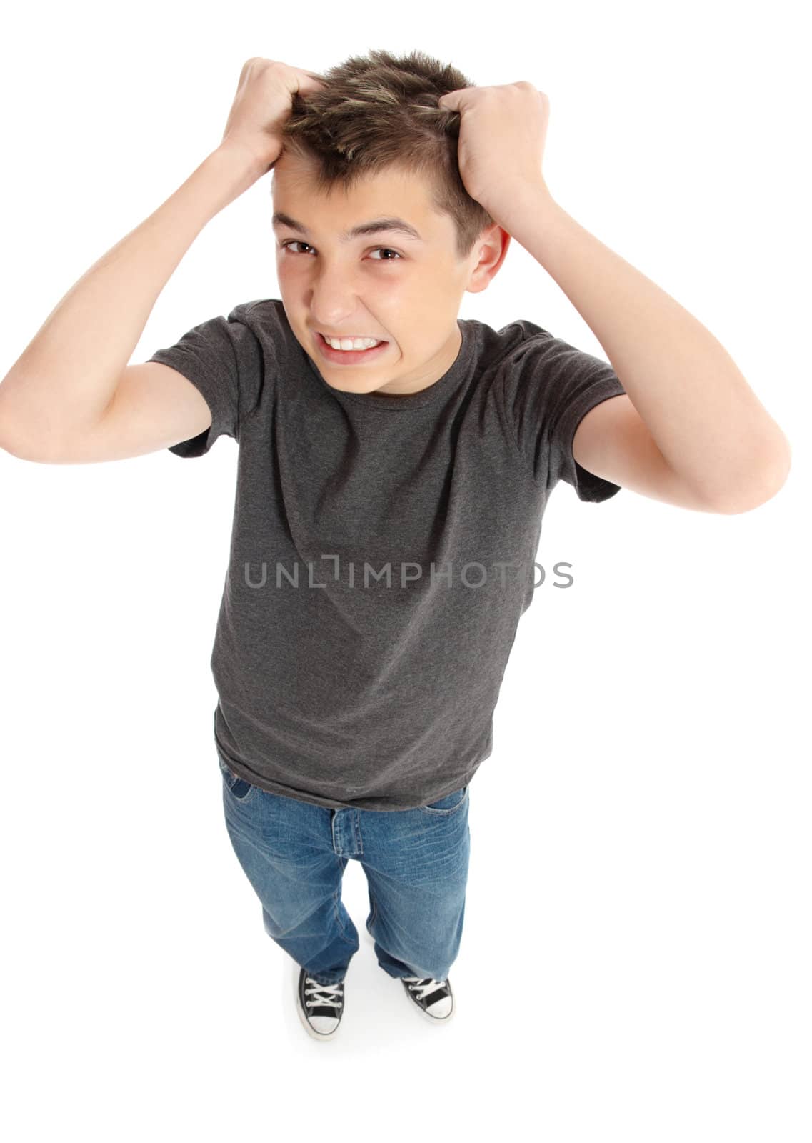 A frustrated and stressed boy or student pulling hair out and grimacing.