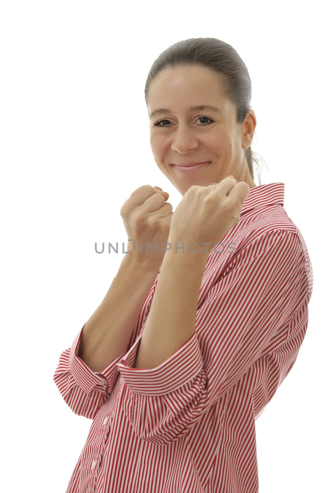 Smiling attractive business woman with a red shirt holding up arms in a fist on a white background
