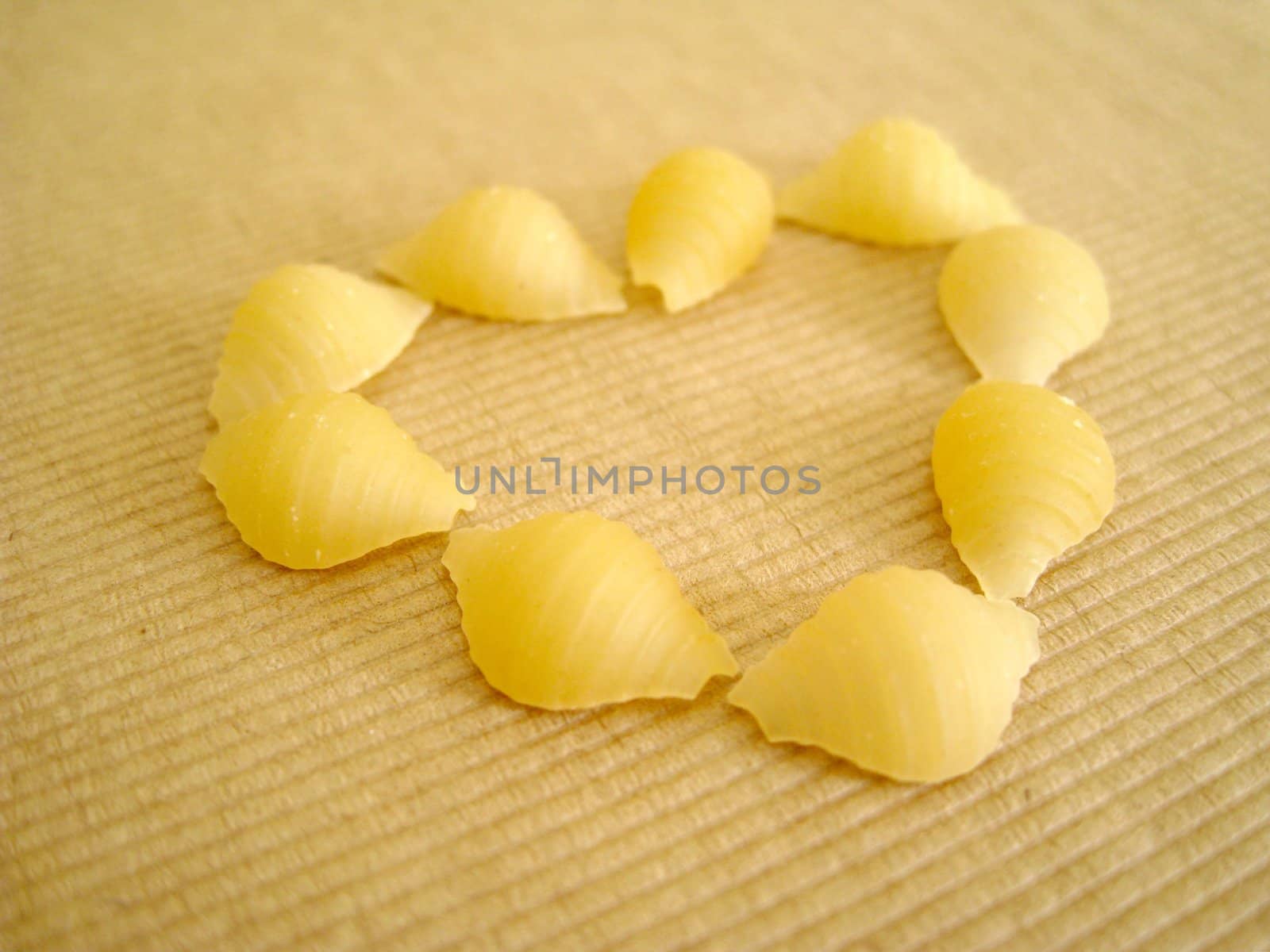 a love shape made by 9 pcs of pasta shell