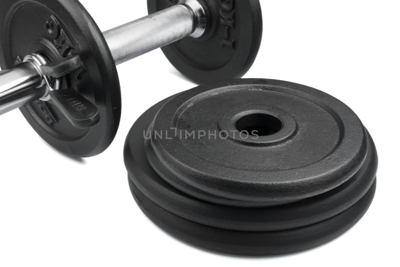 Stack of black weights on a white background. Horizontal shot.