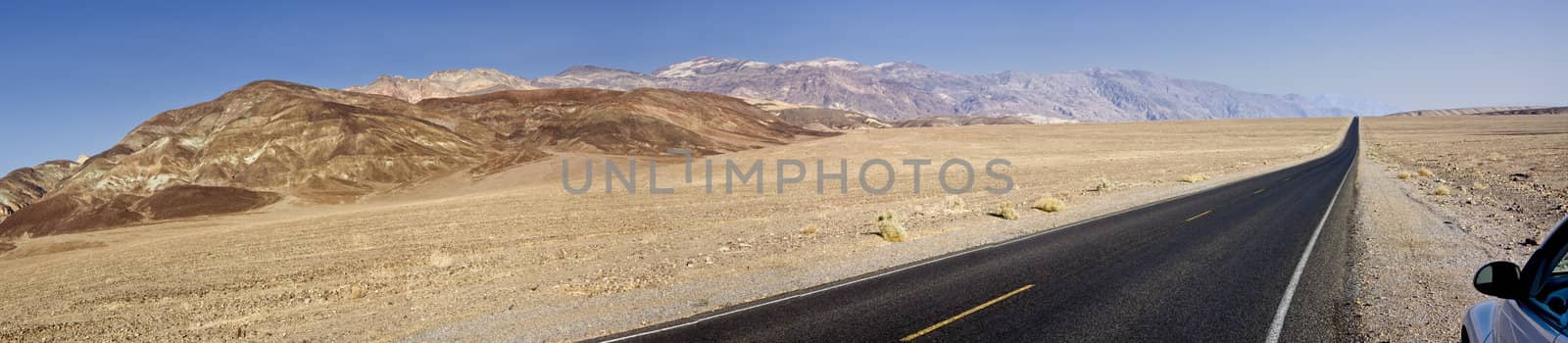 Car on the side of a road in California, United States. Panoramic shot.