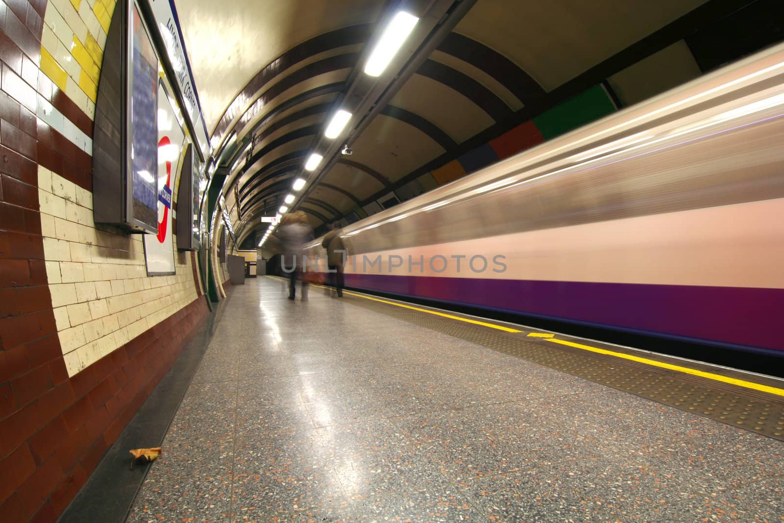 Subway train rushing by the station