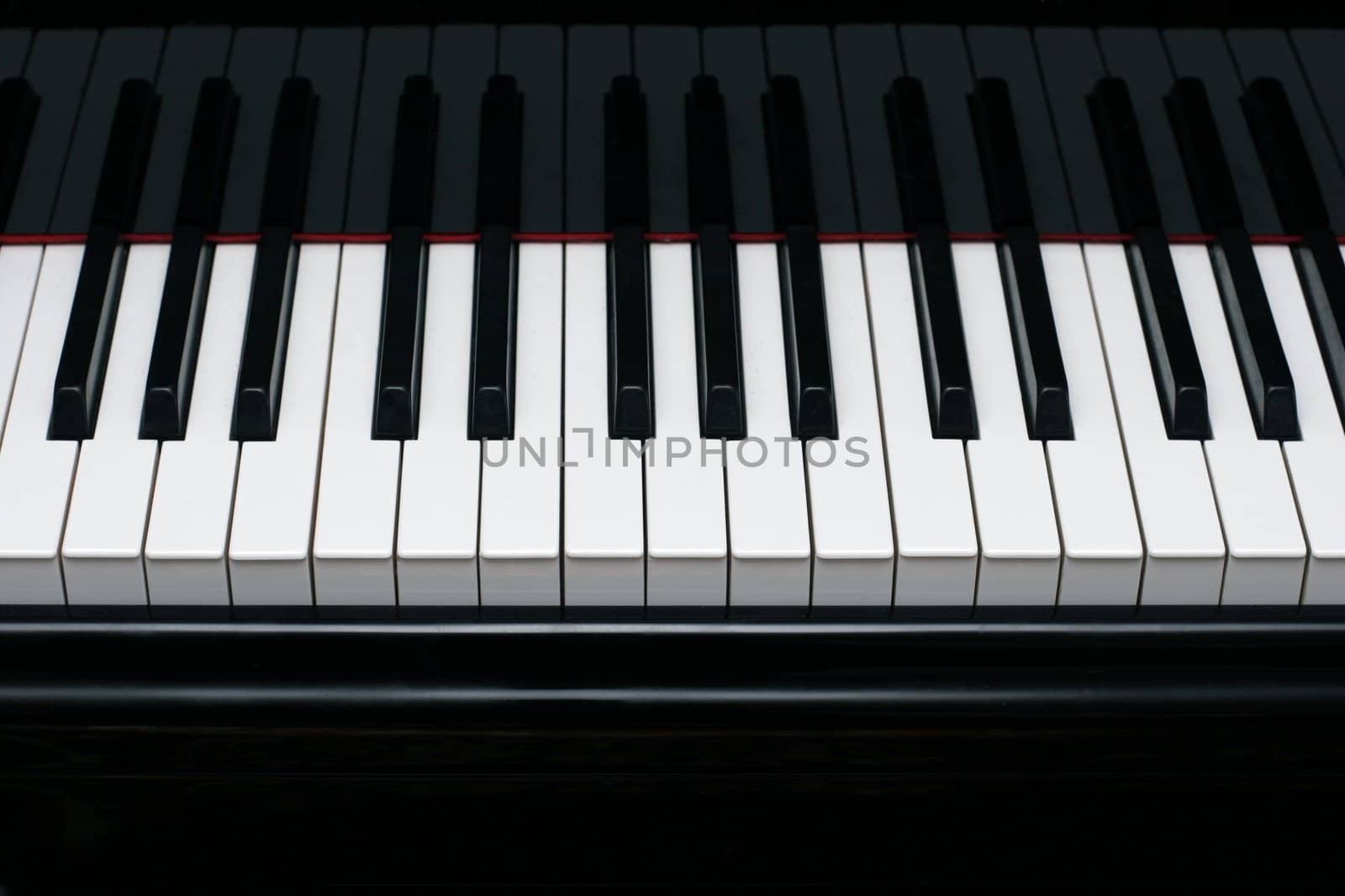 Close-up of a shiny grand piano ebony and ivory keys