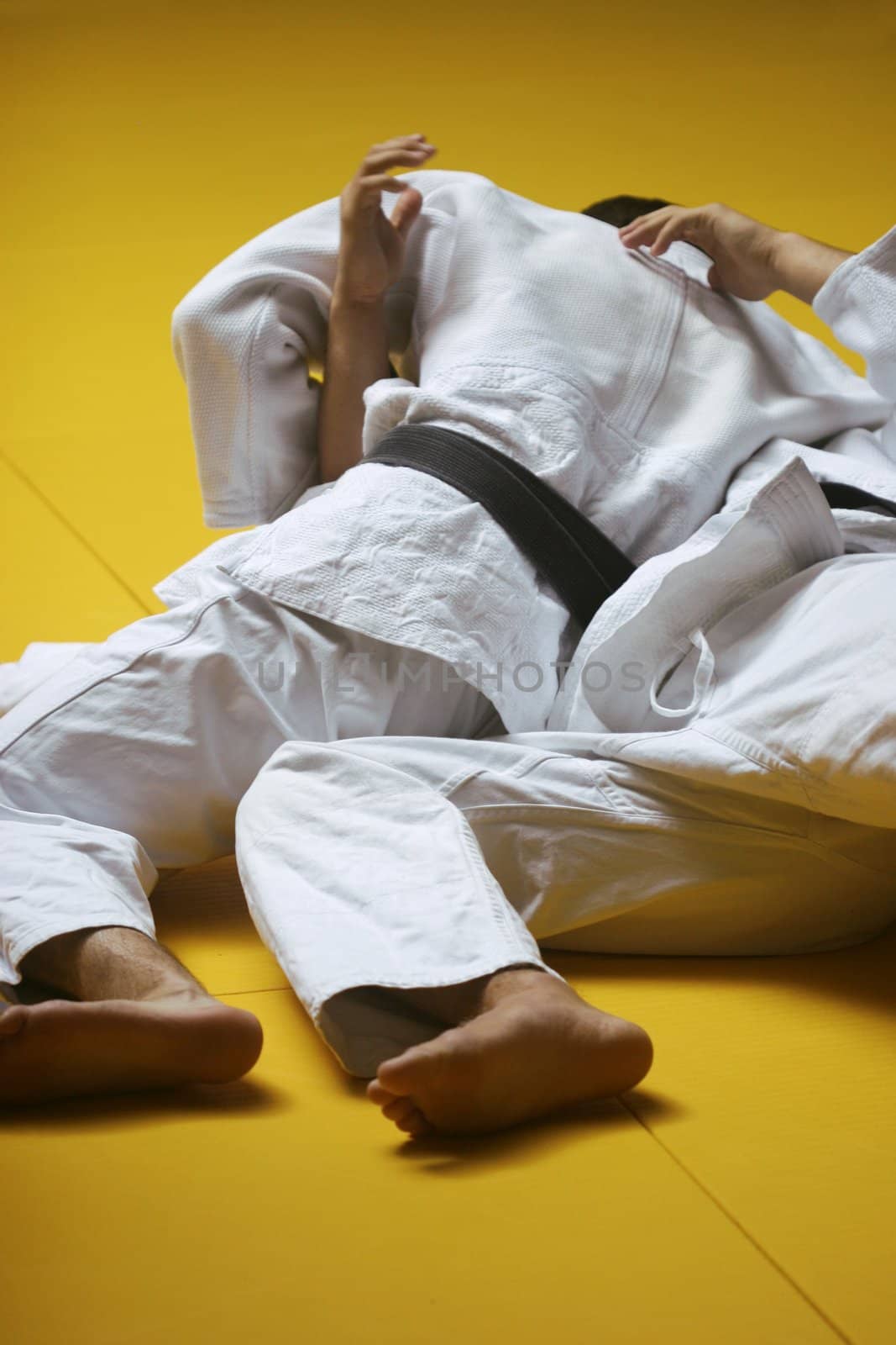 Judo fighters wrestling for supremacy - some grain visible