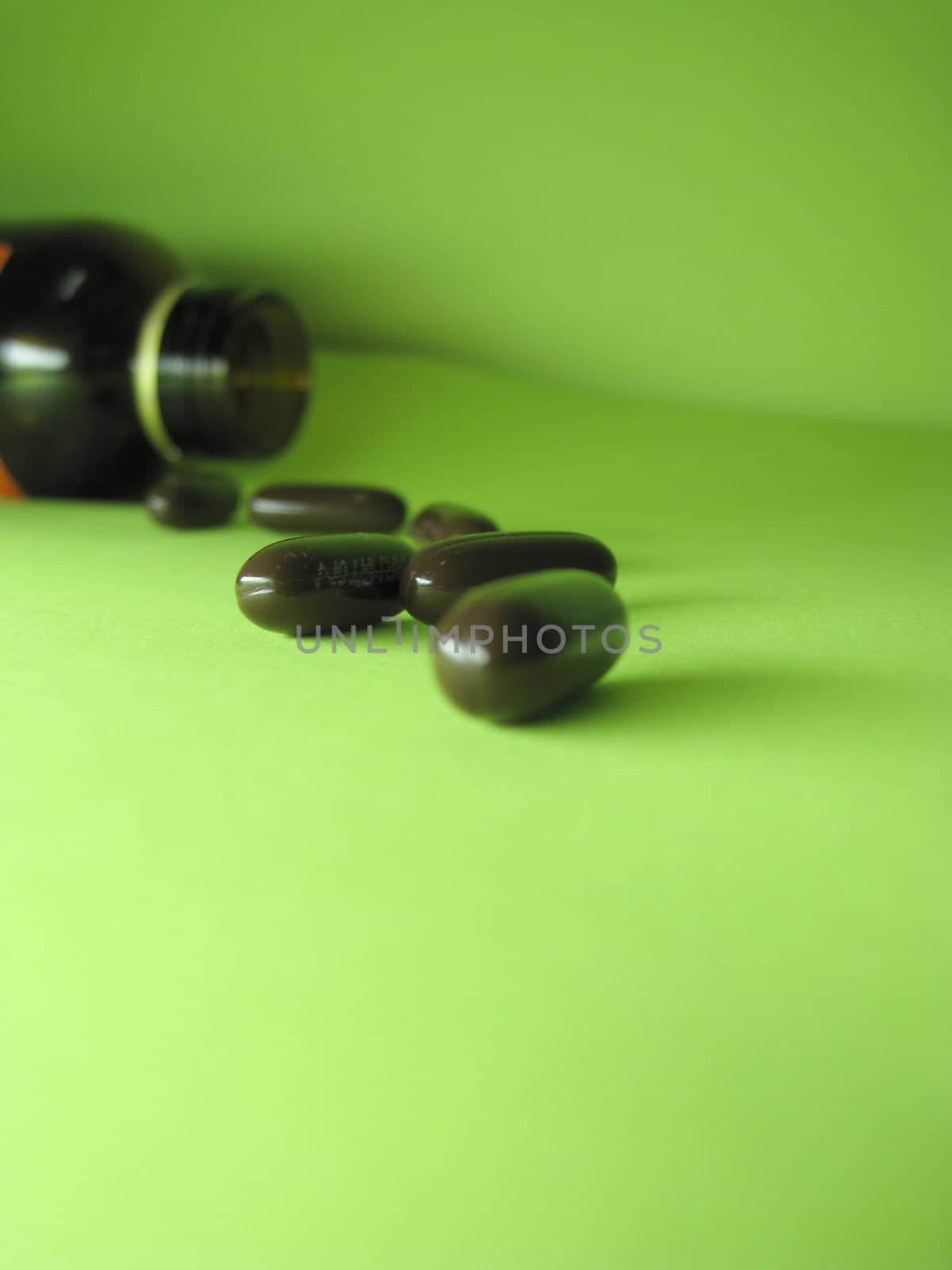 a bottle of pills on a green background