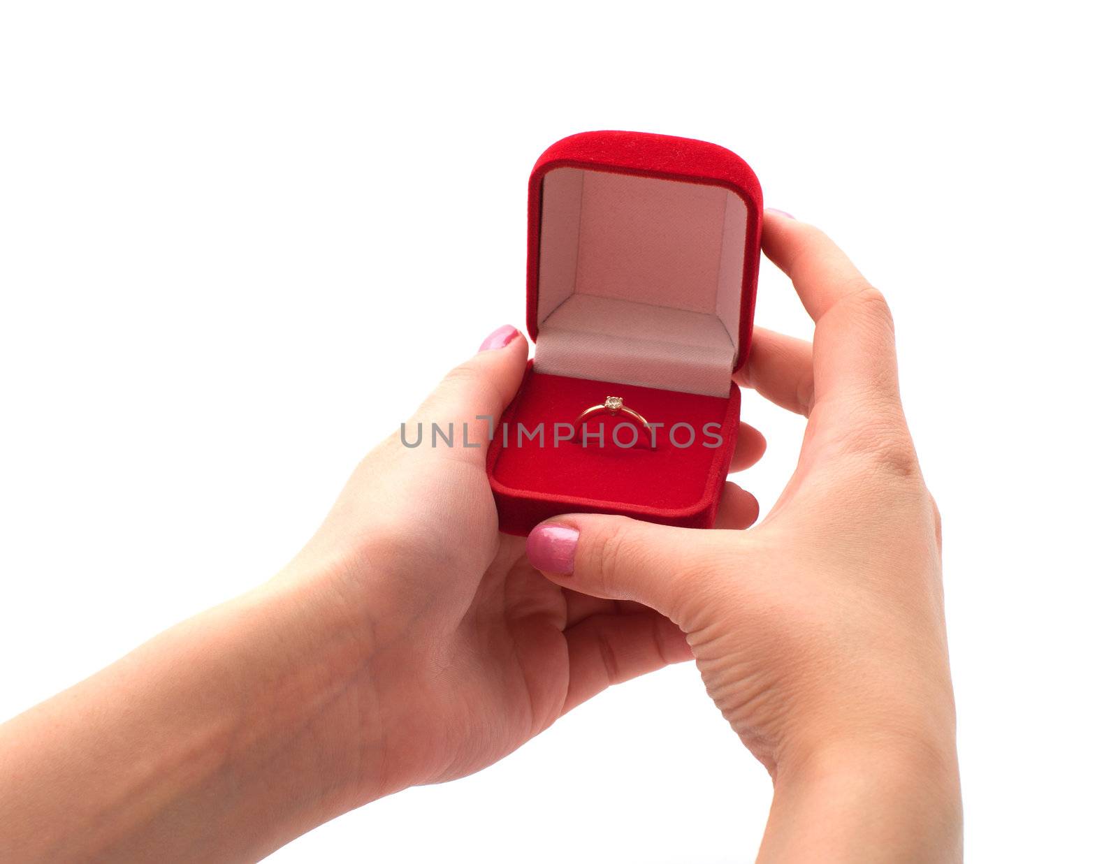 Female hand holding a red box with a gold ring isolated on a white background.